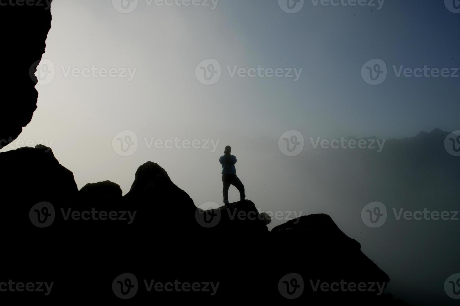 silhouette person on the hill photo