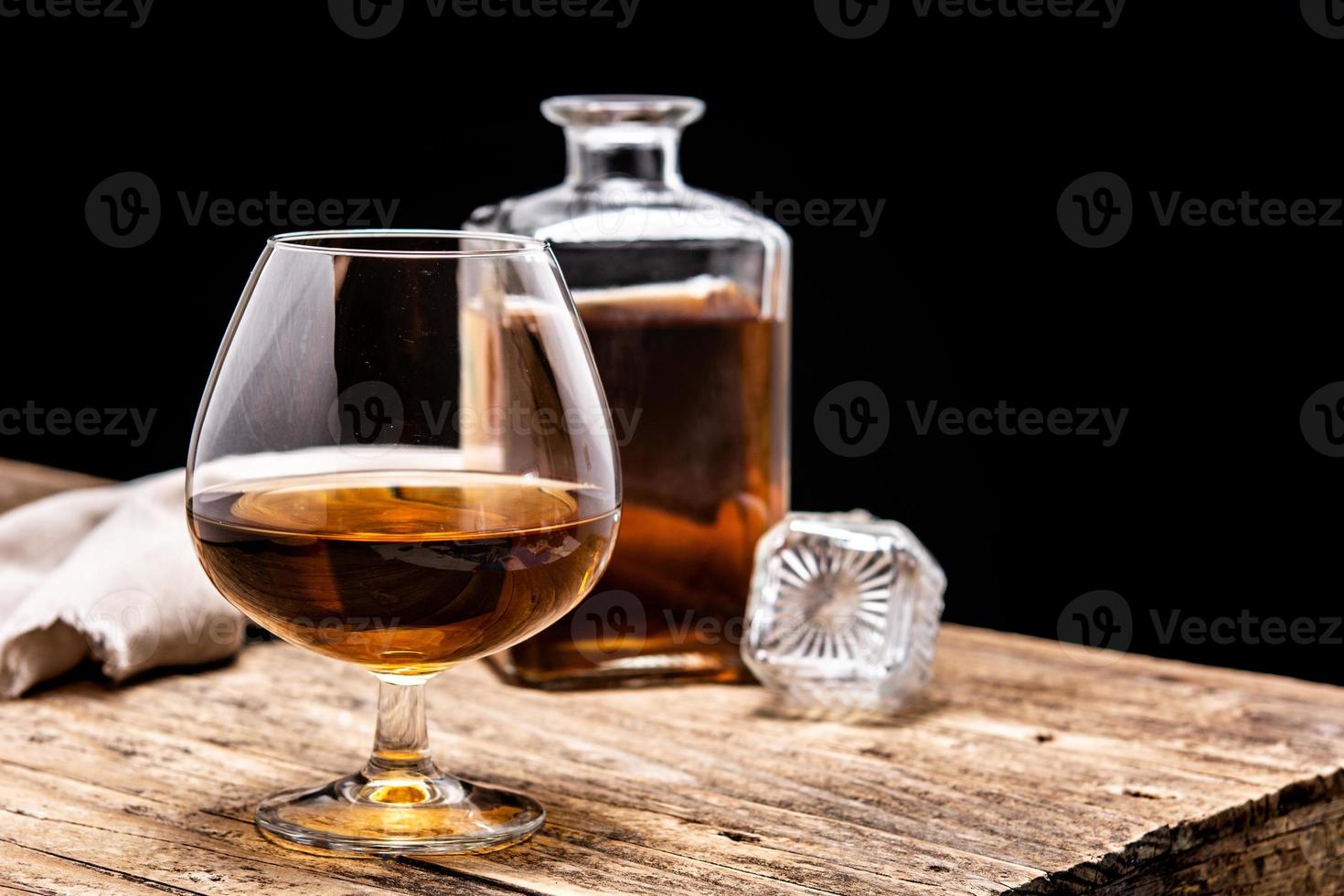 Cognac or whiskey drink on rustic photo