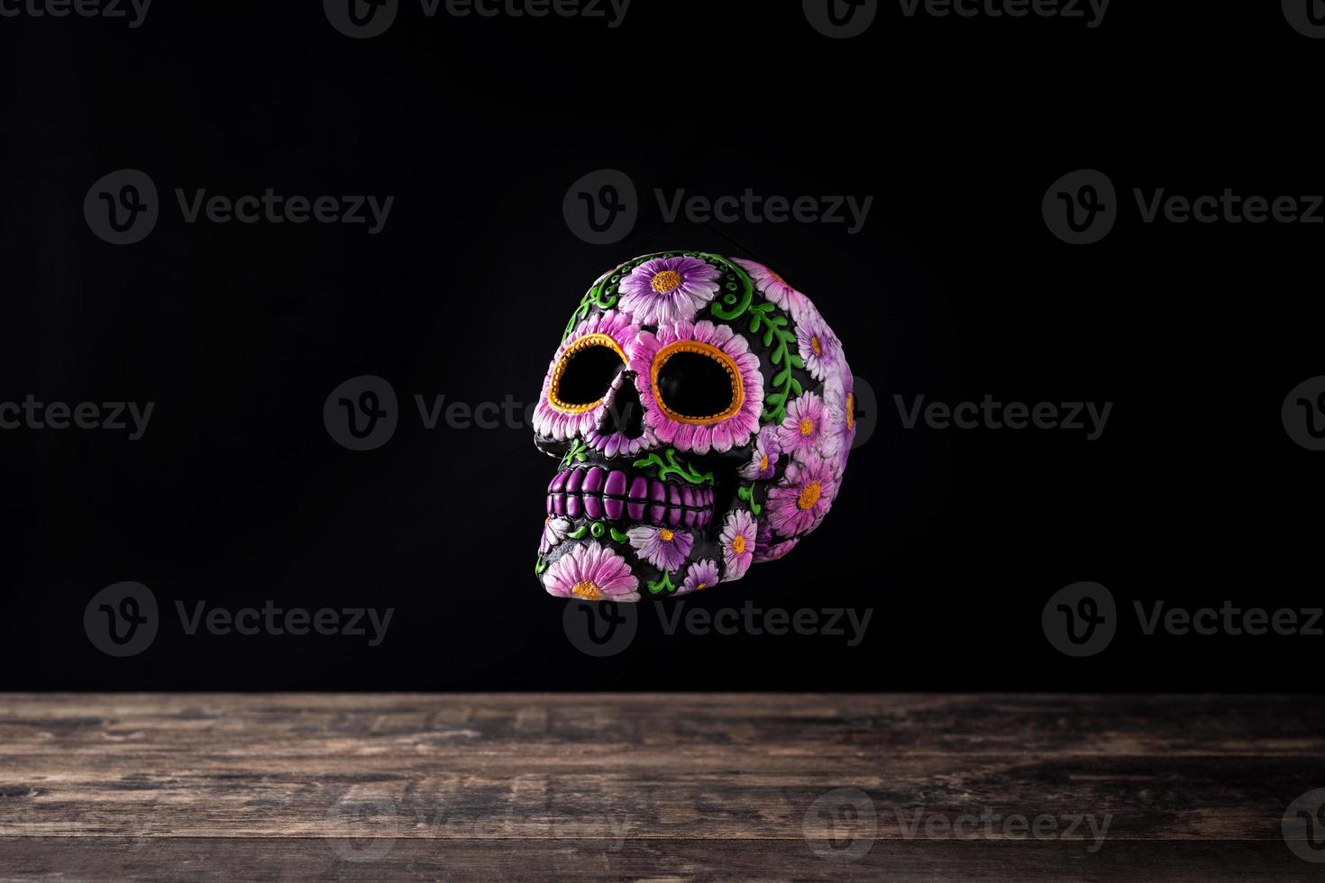 Typical Mexican skull floating in the air and flowers diadem photo