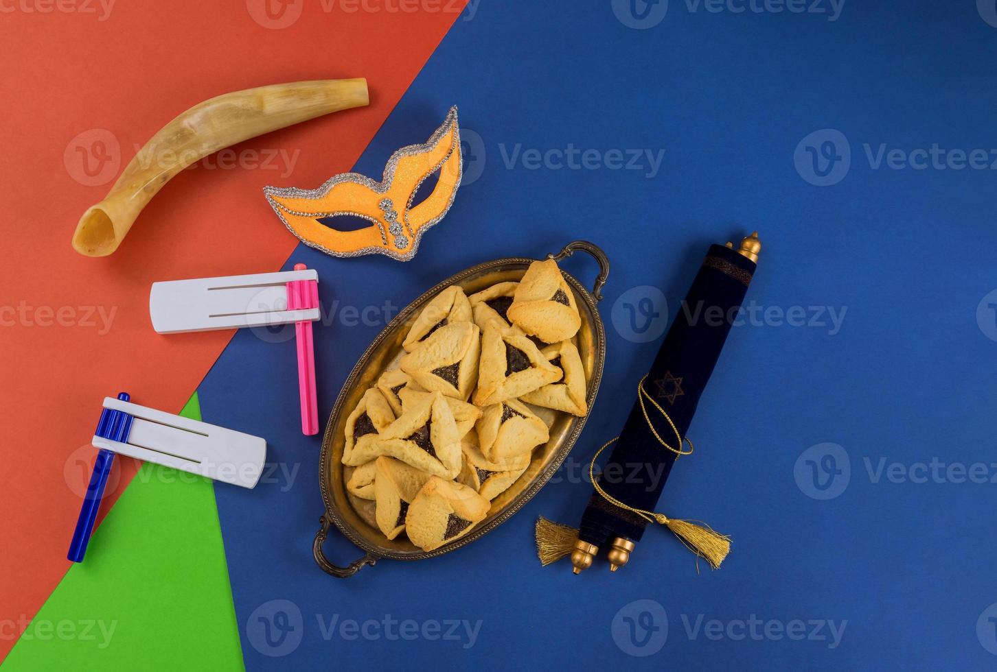 Jewish holiday Purim with hamantaschen cookies hamans ears, carnival mask and parchment photo