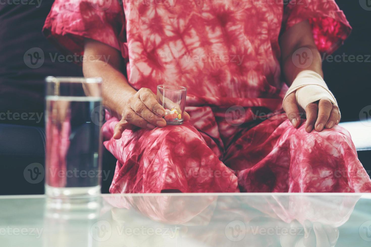 Senior asian woman take pill medicine on hand photo