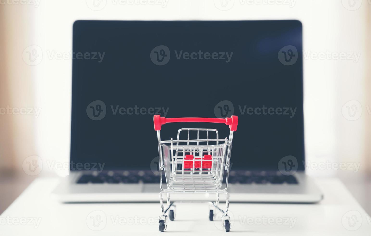 shopping cart with laptop on the desk photo