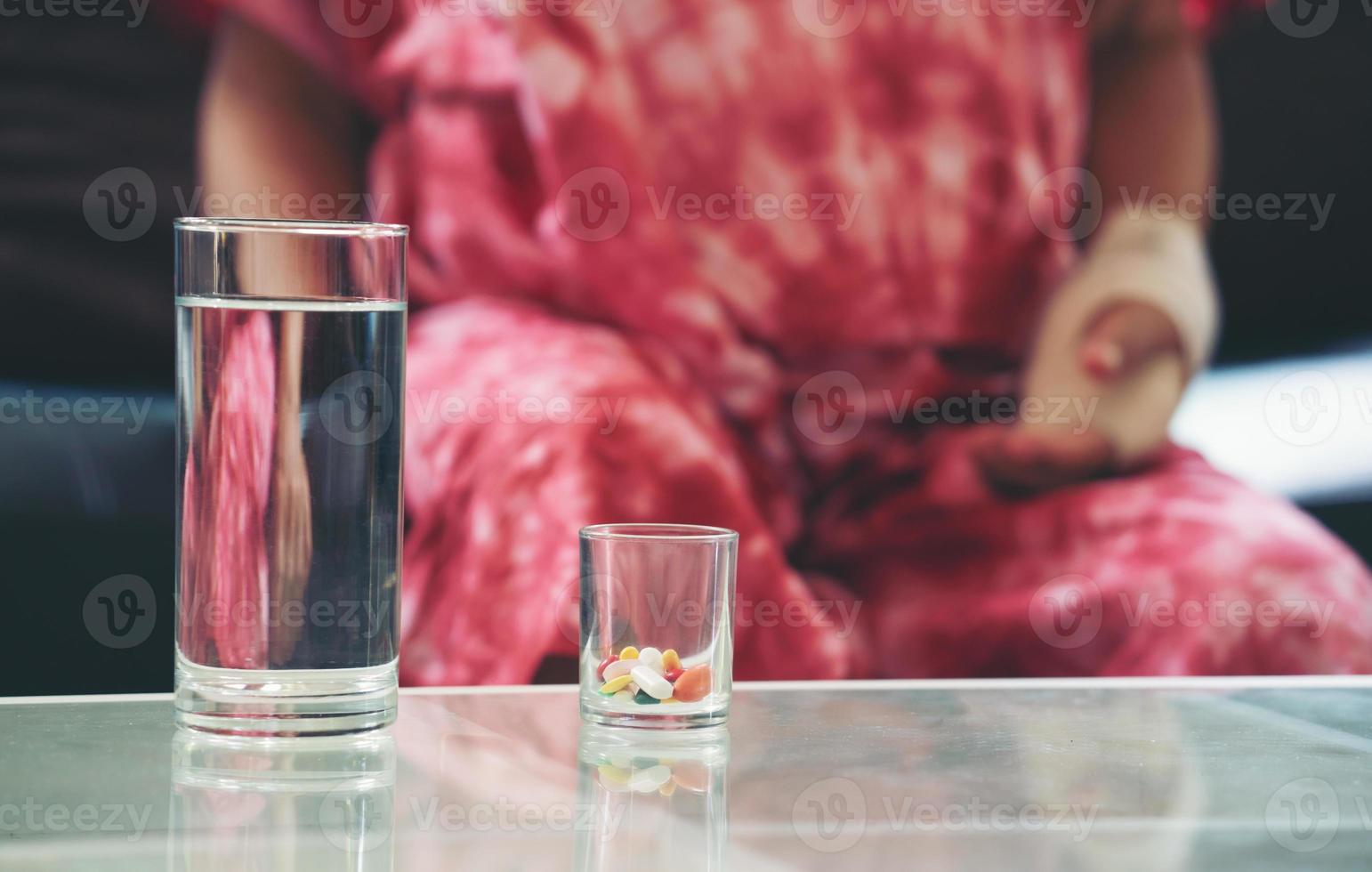 Senior asian woman take pill medicine on hand photo