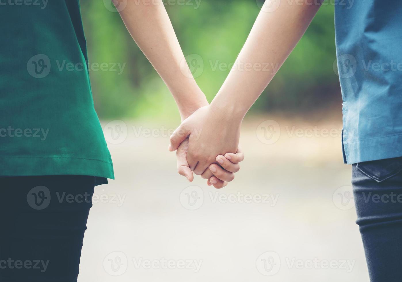 two asian woman holding hands photo