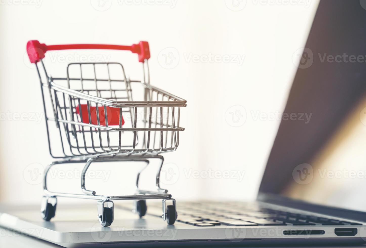 shopping cart with laptop on the desk photo