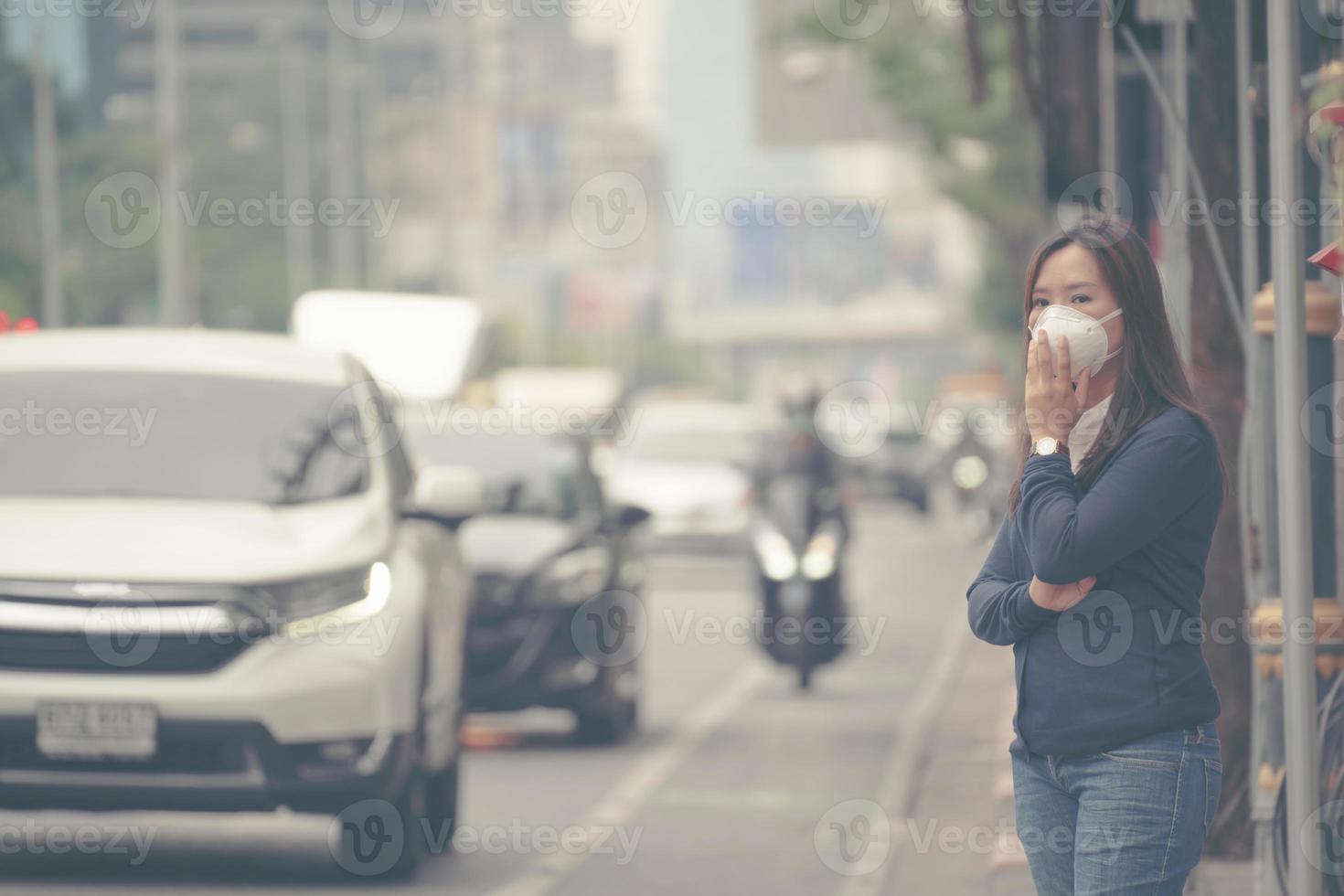 woman wearing protective mask in the city street photo