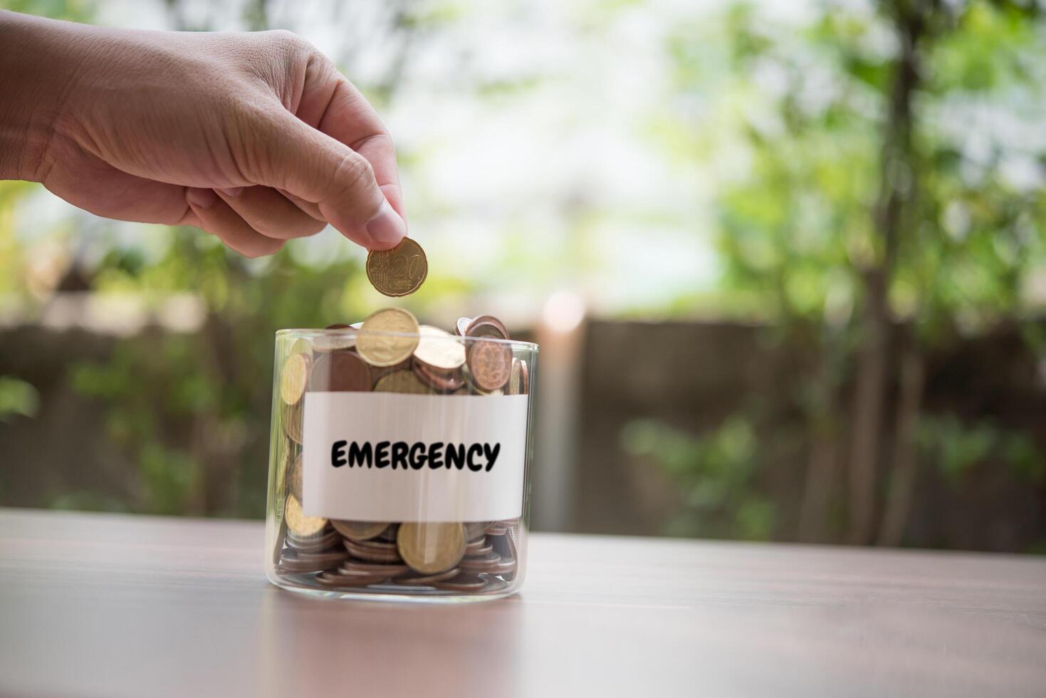 Hand  putting coins in jar with money stack step growing growth saving money photo