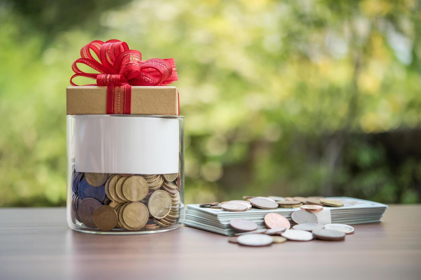 Gift box on dollars  in the glass jar photo