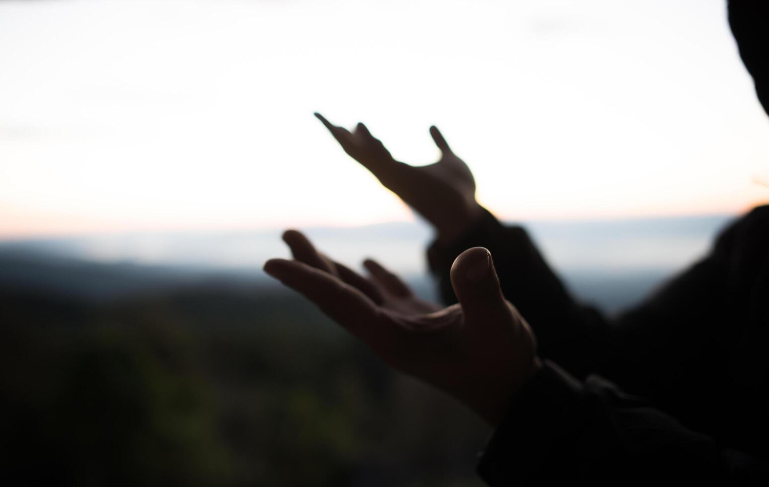 Silhouette of Hand hold cross of God photo