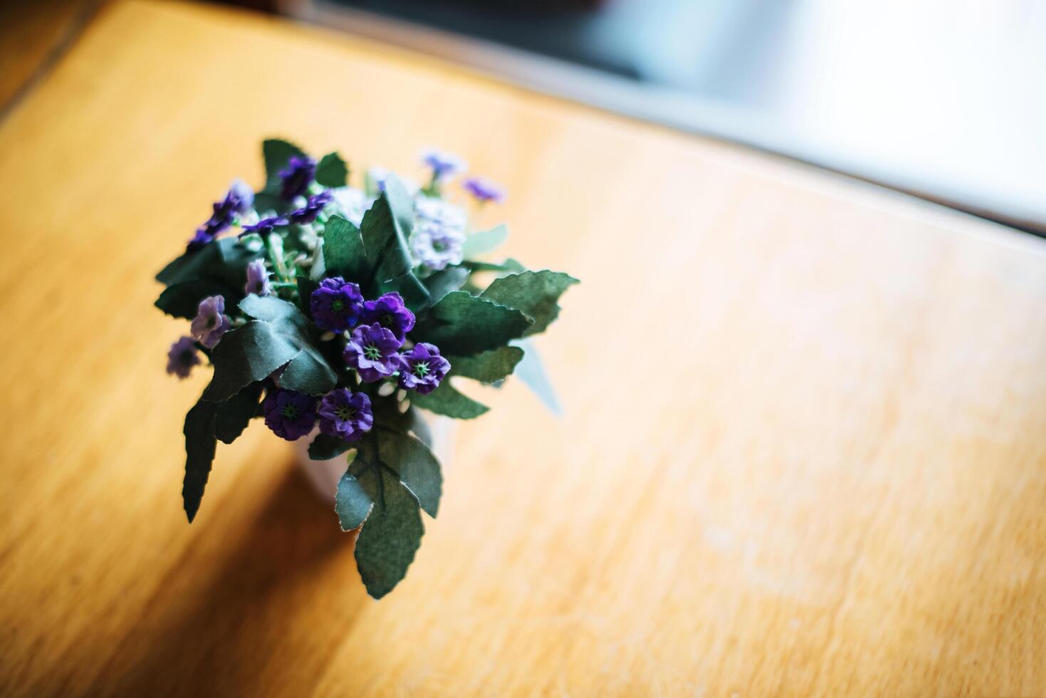 Flower in vase on table at coffee shop photo