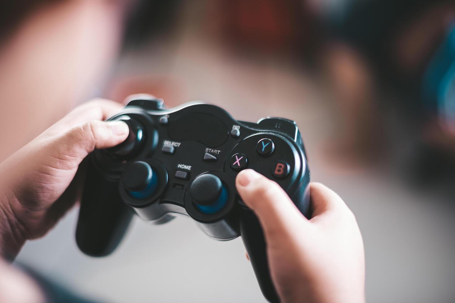 Happy boy play game computer with a controller in studio photo