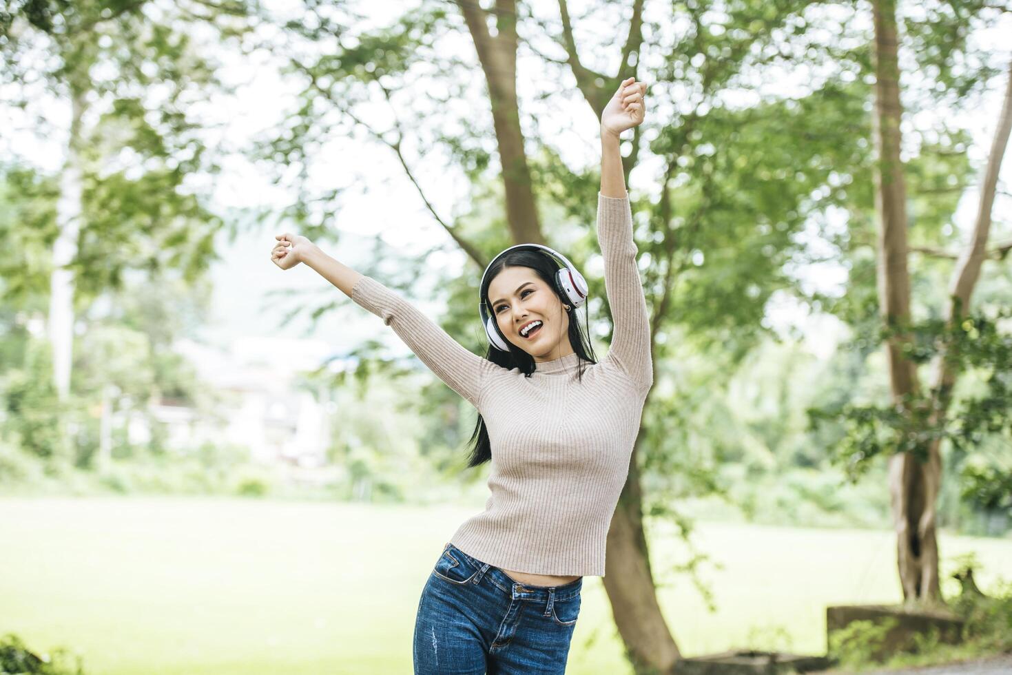 Asian woman listening favorite music on headphones. Happy time and relax. photo