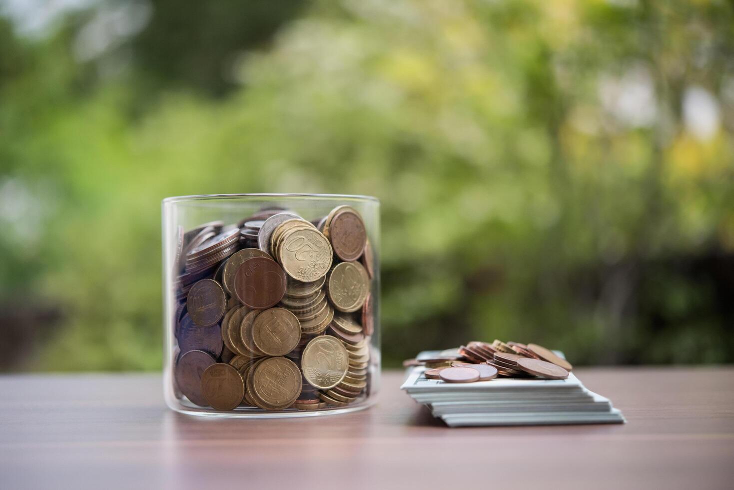 save money for investment concept coin in the glass jar photo