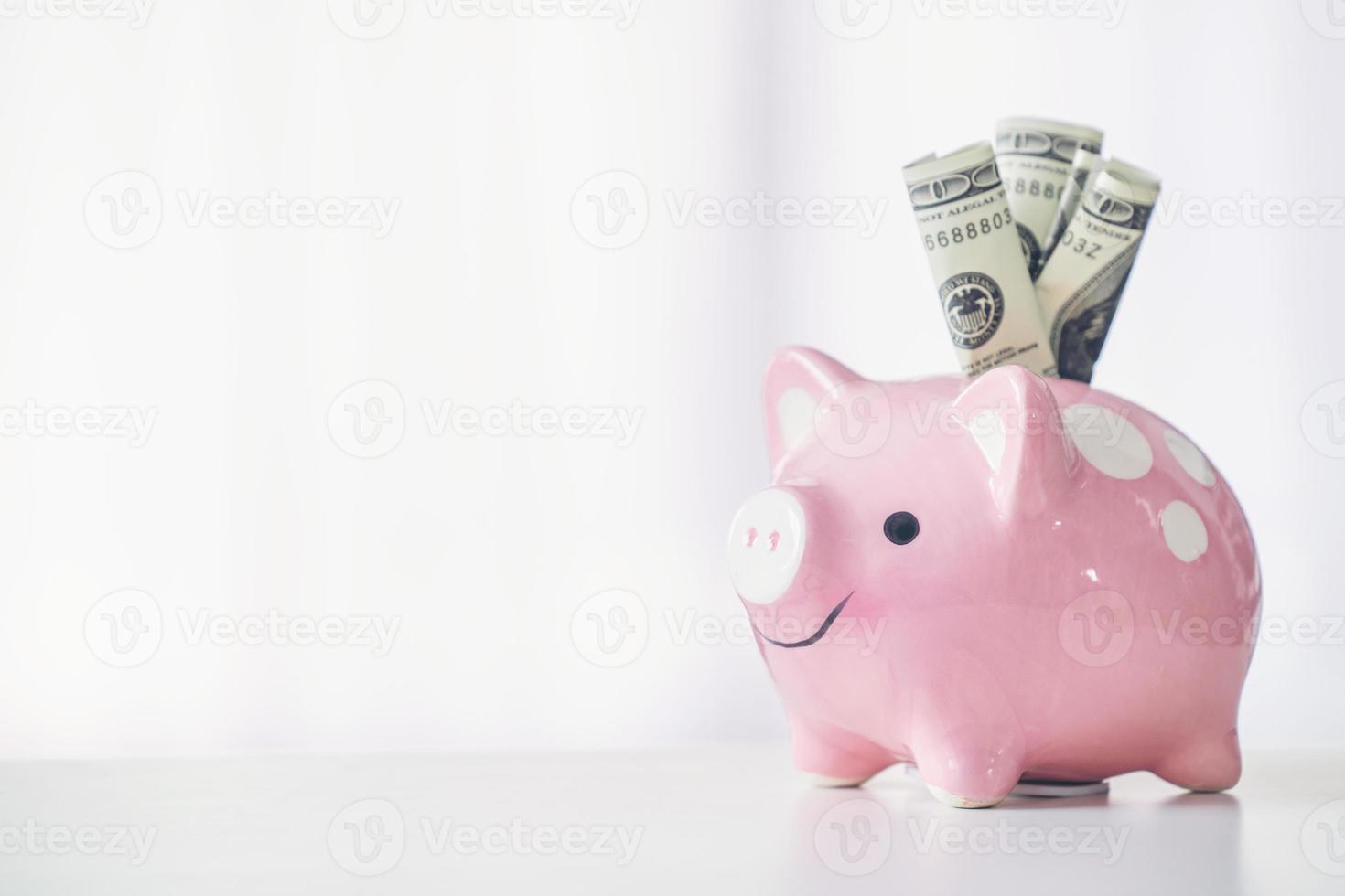 pink color piggy bank on white table photo