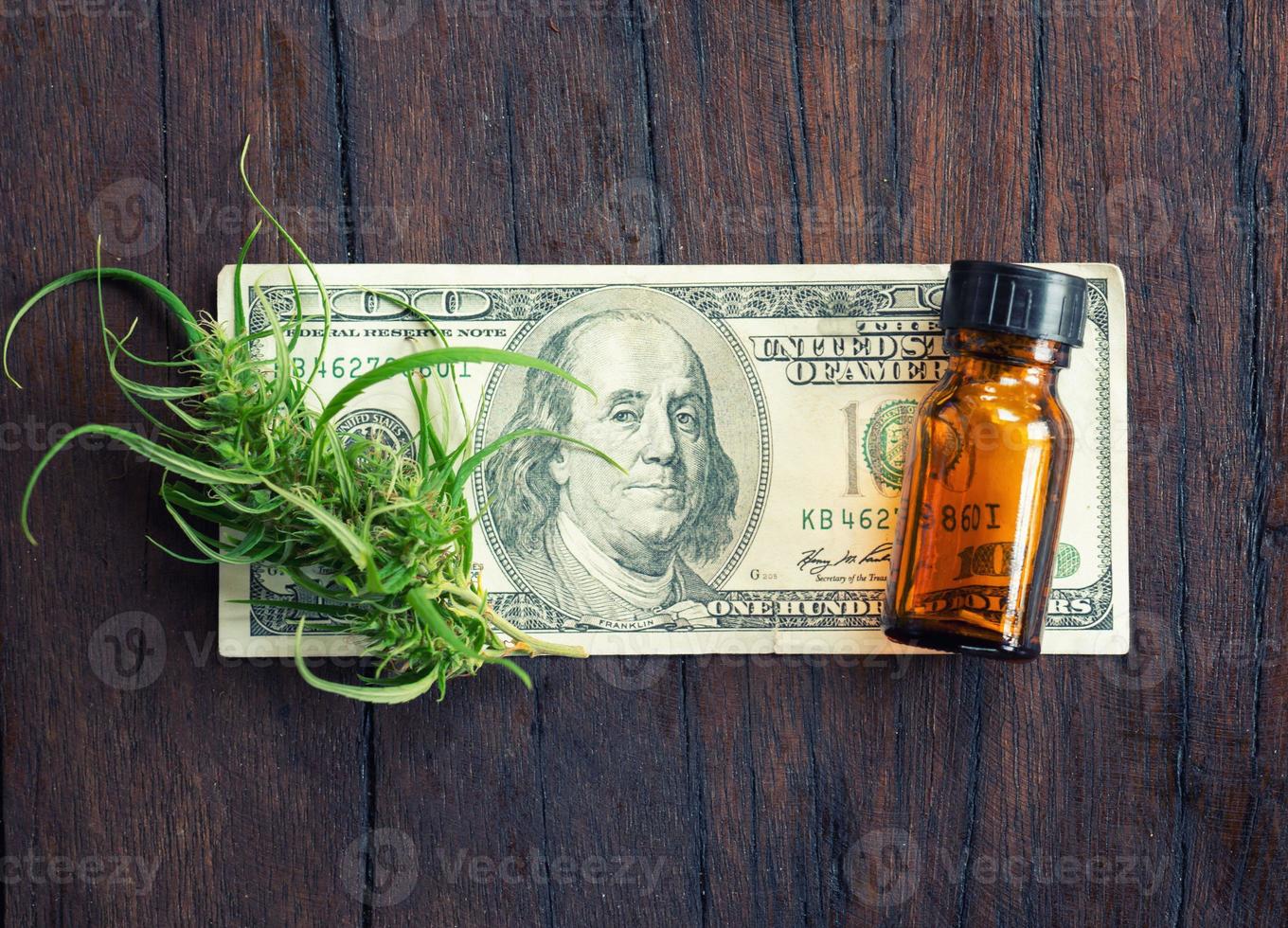 Cannabis con extracto de CBD de cannabidiol en billetes de dólar foto