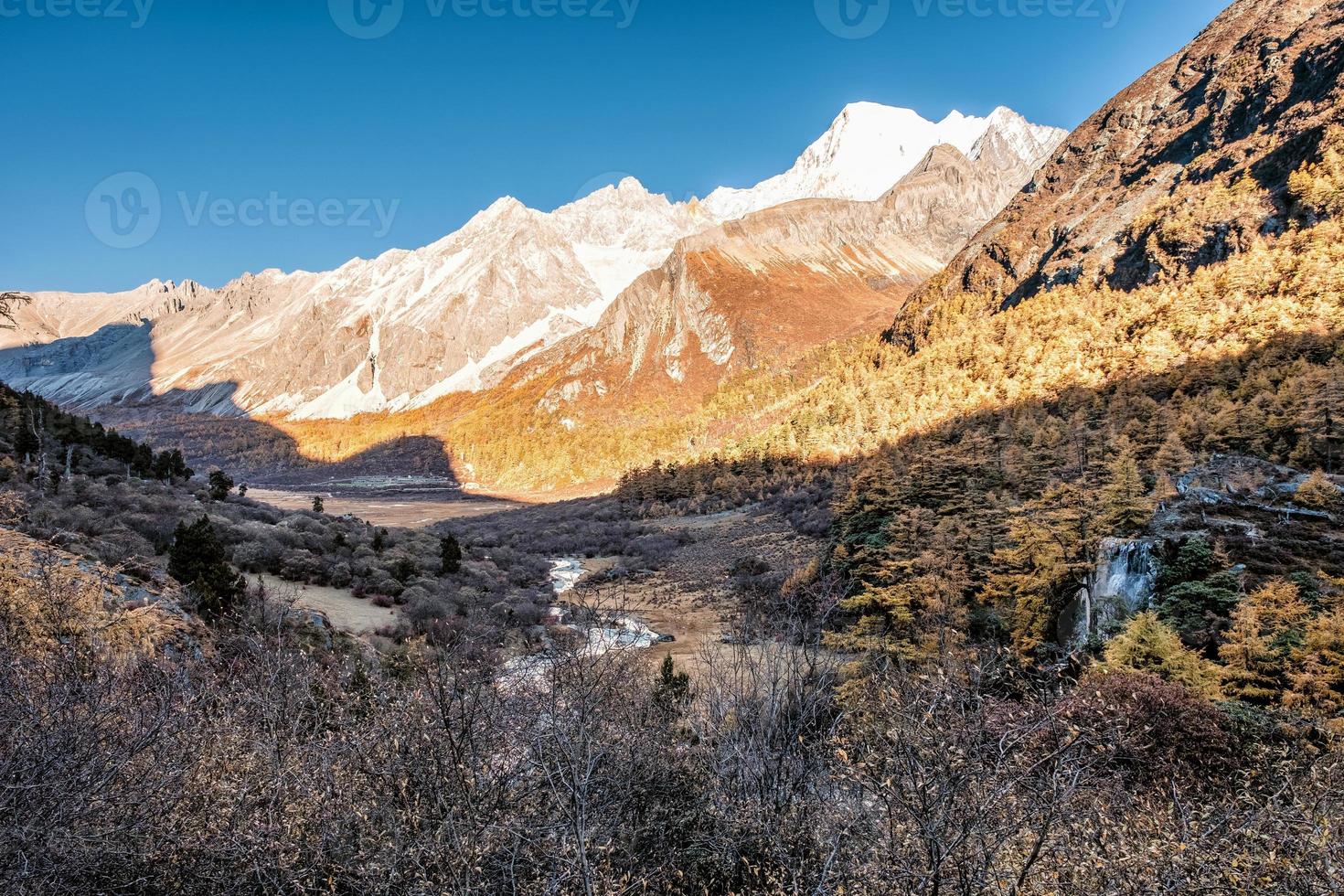 Holy mountain range with waterfall in pine forest in autumn photo