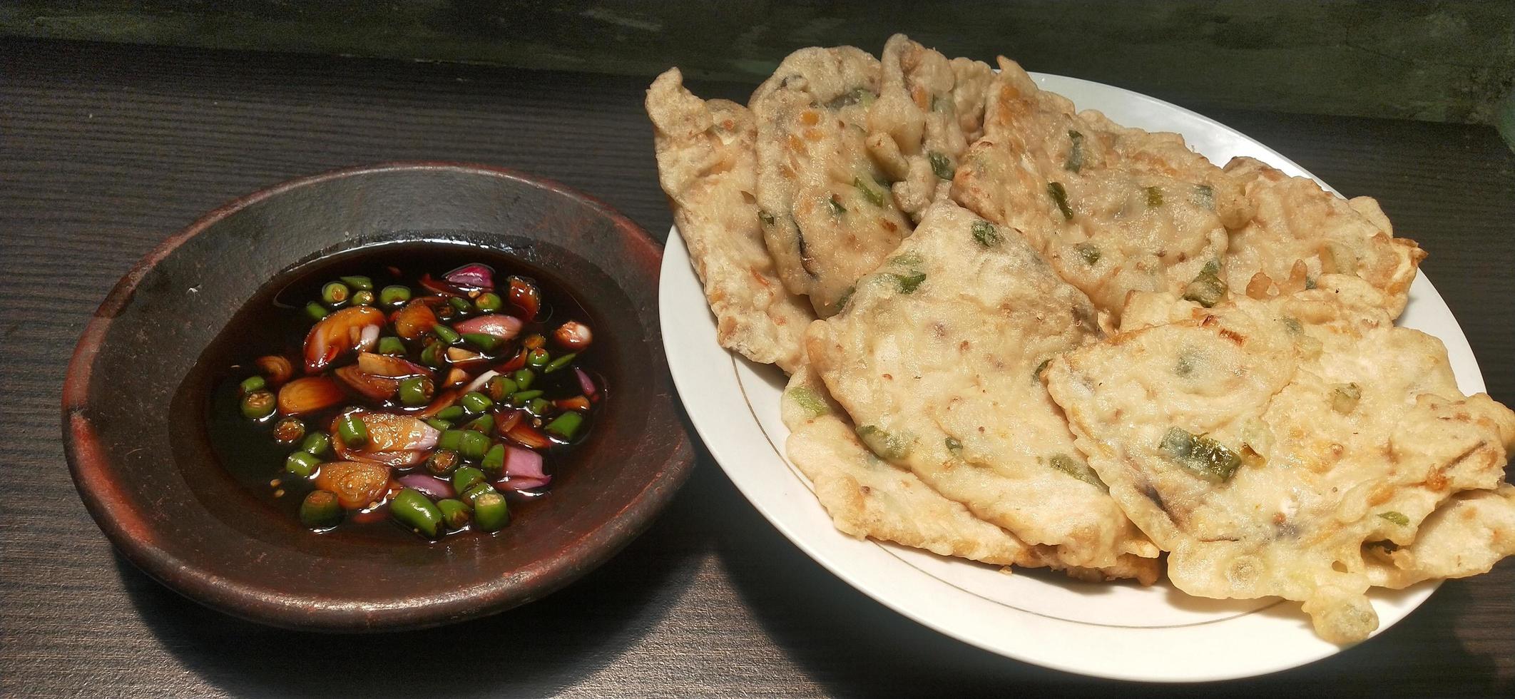 Tempe Mendoan is a traditional food from Banyumas, Central Java, Indonesia, made from fermented soybeans wrapped in banana leaves photo