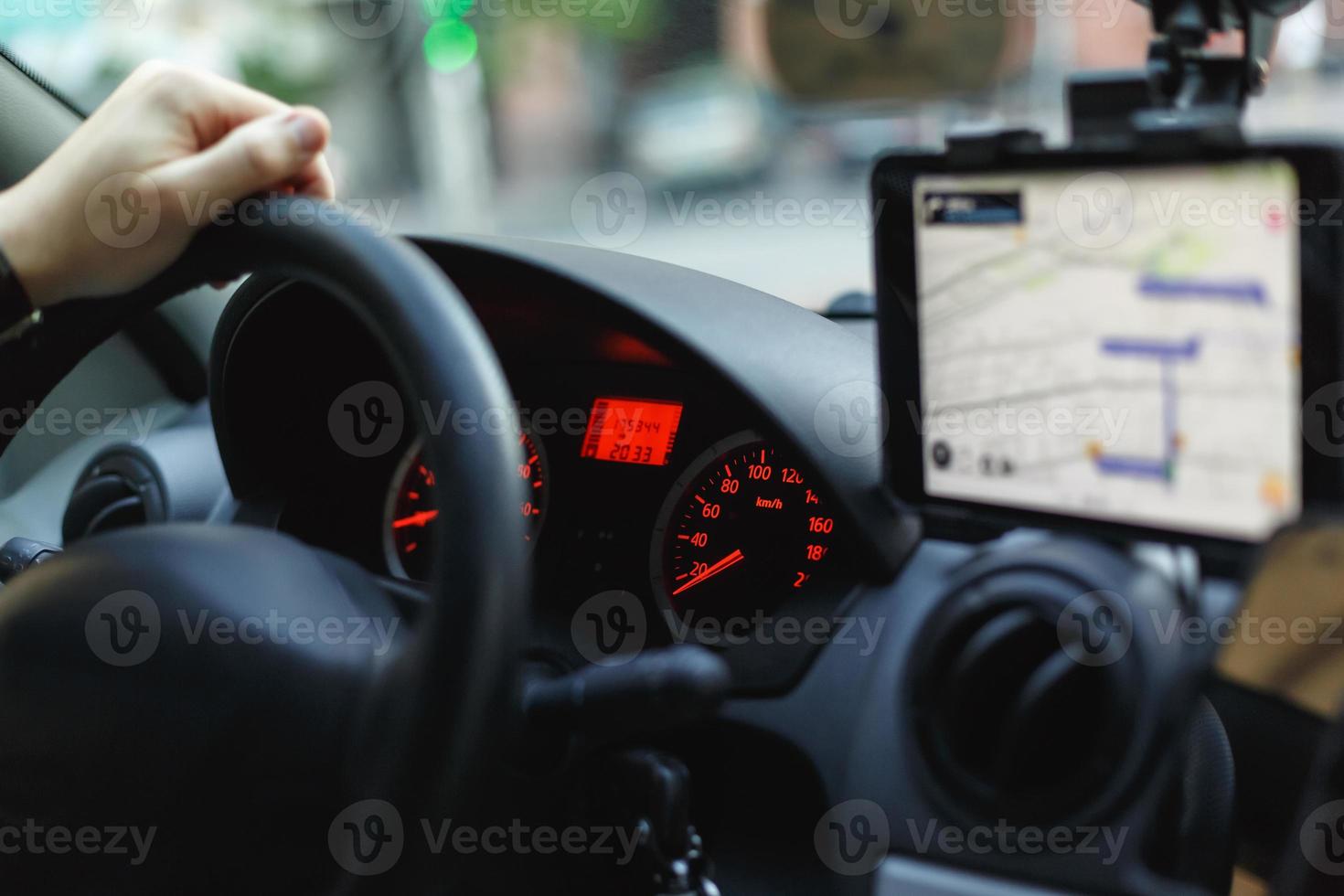 View of a speedometer, steering wheel and navigator on a dashboard photo