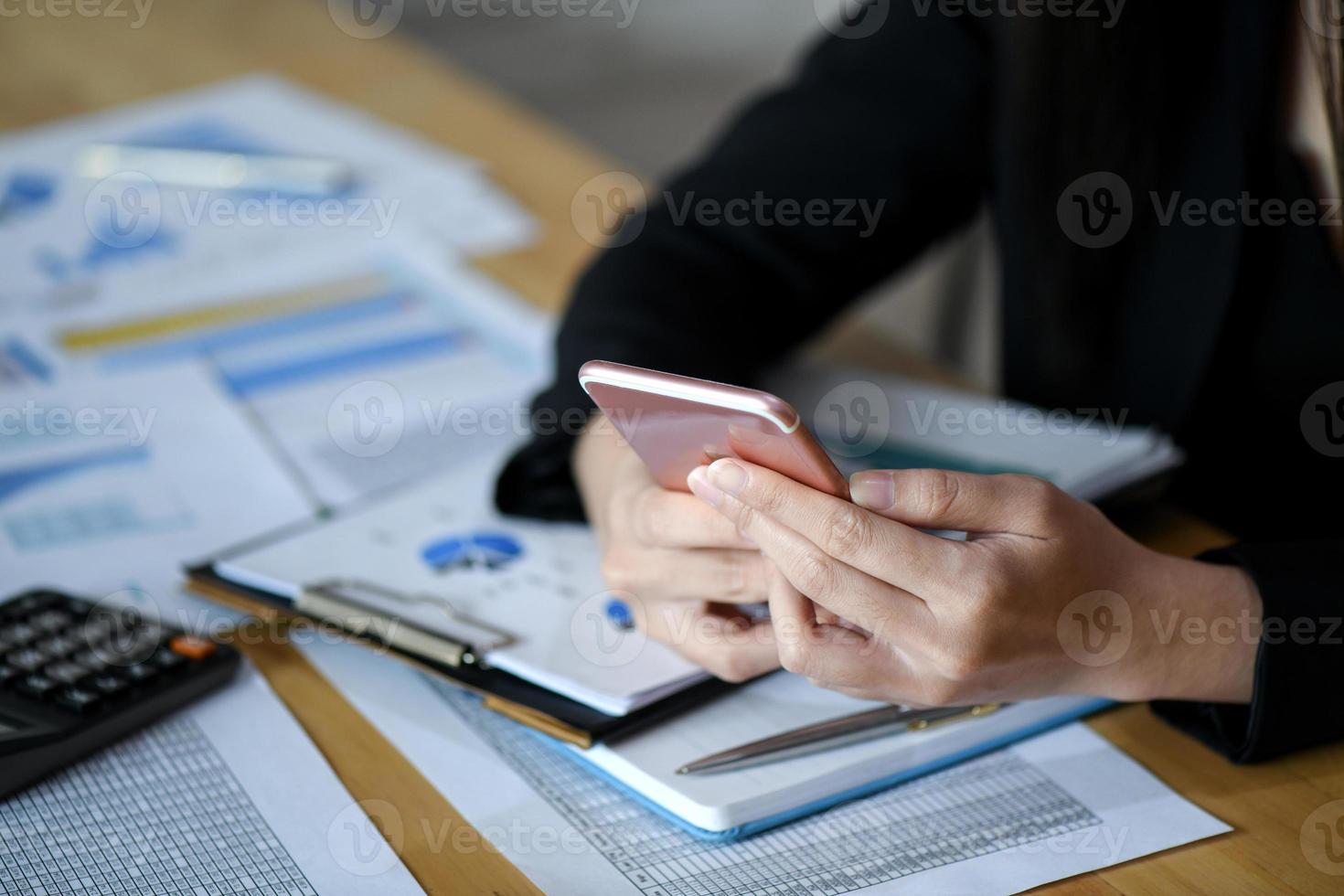 Female executives are using smartphone in the office. photo