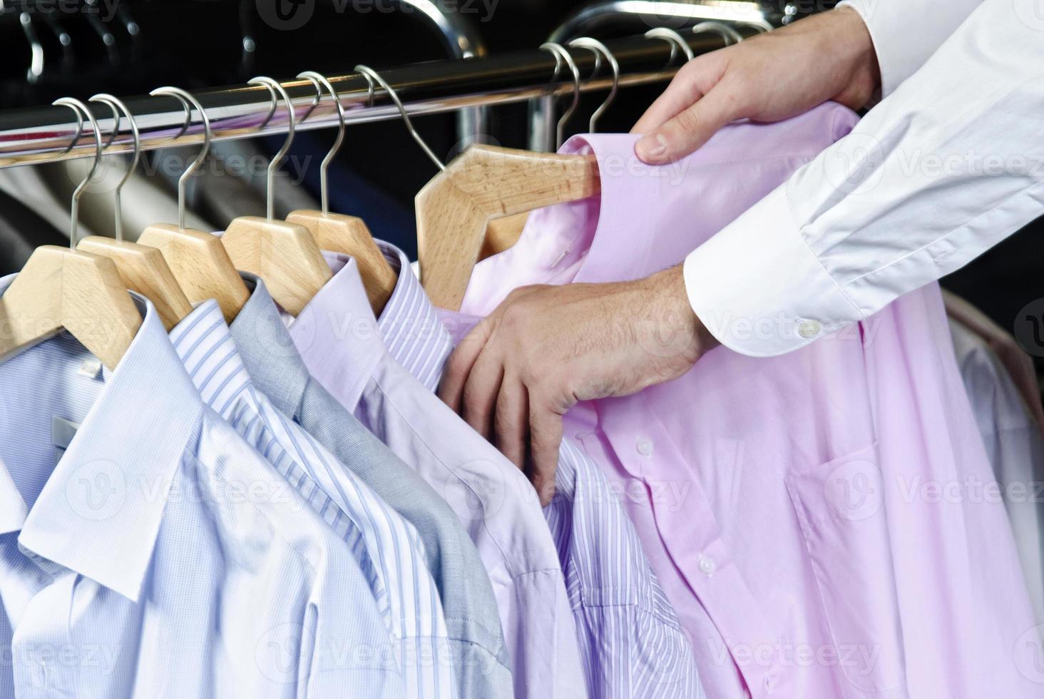 Raw of different colors man's jackets hanging photo