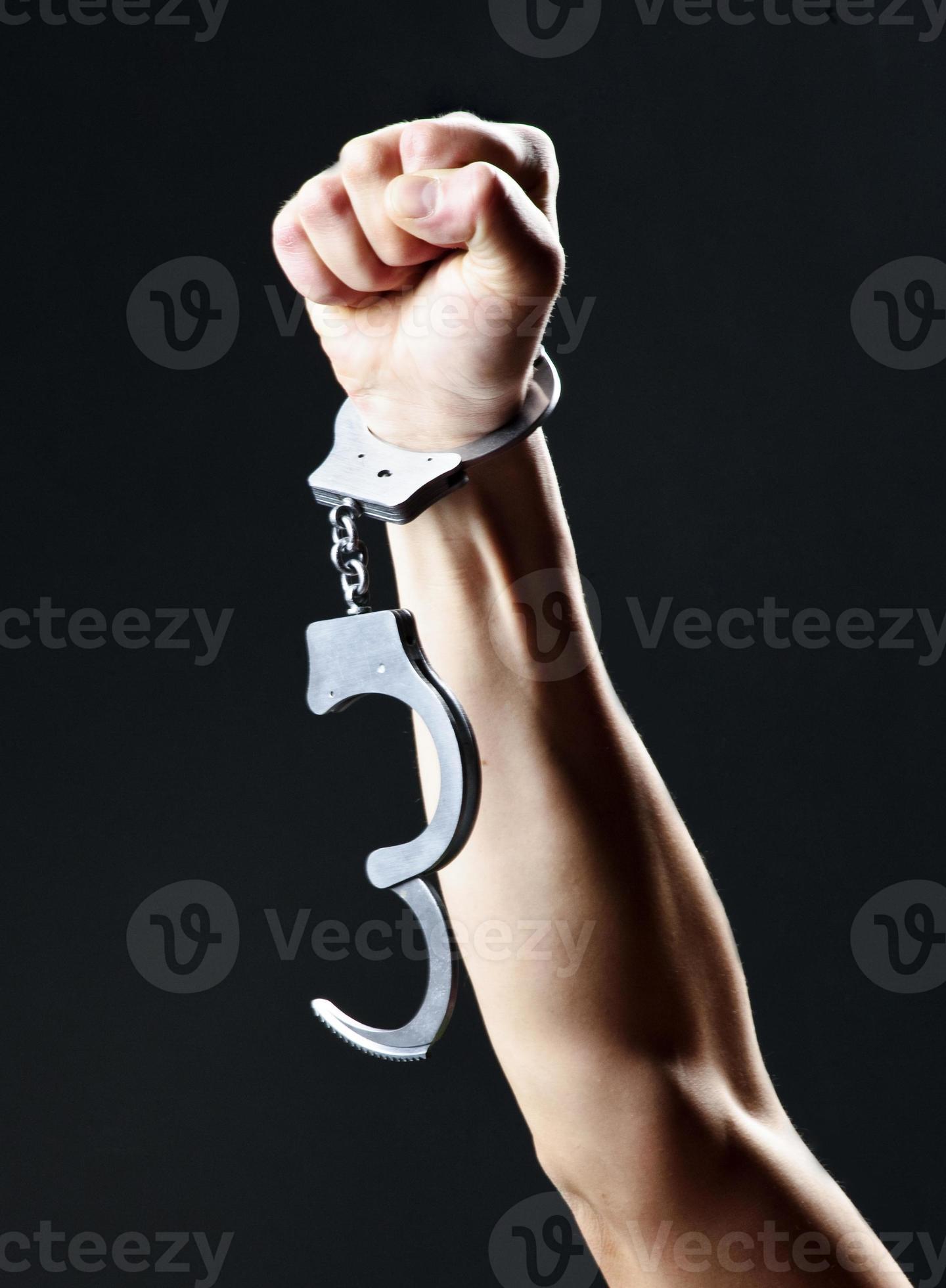 Picture of handcuffs,hanging on stretched hand 3618118 Stock Photo at