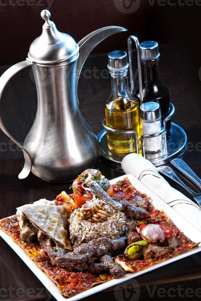 Pilaf - Rice with Lamb Chops and Vegetables. Garnished with Onions and Tomatoes Salad photo