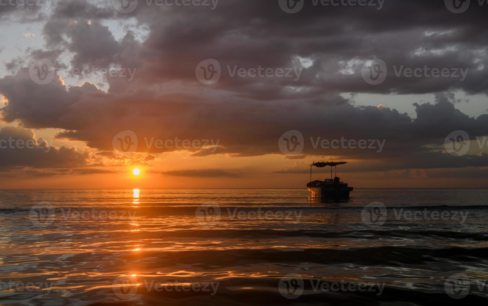 Silhouette fishery boats in the sunset time. photo