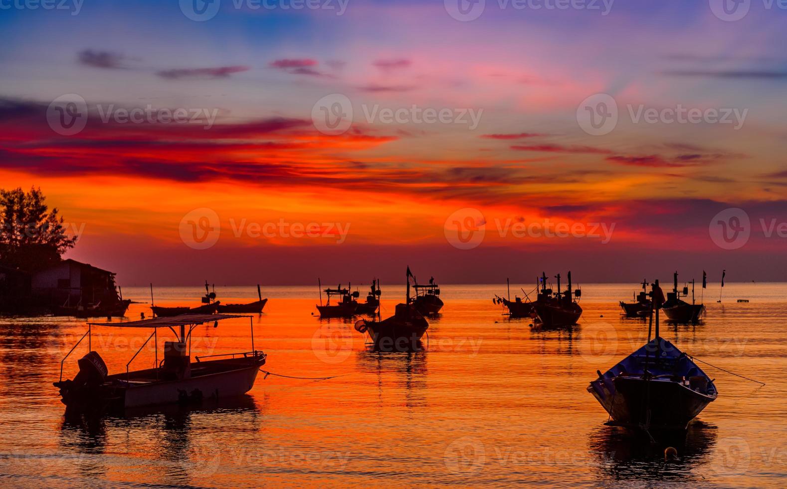 Silhouette fishery boats in the sunset time. photo