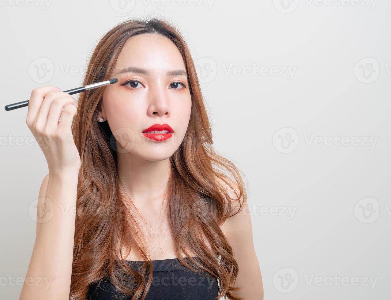 portrait beautiful woman with makeup eye brush photo