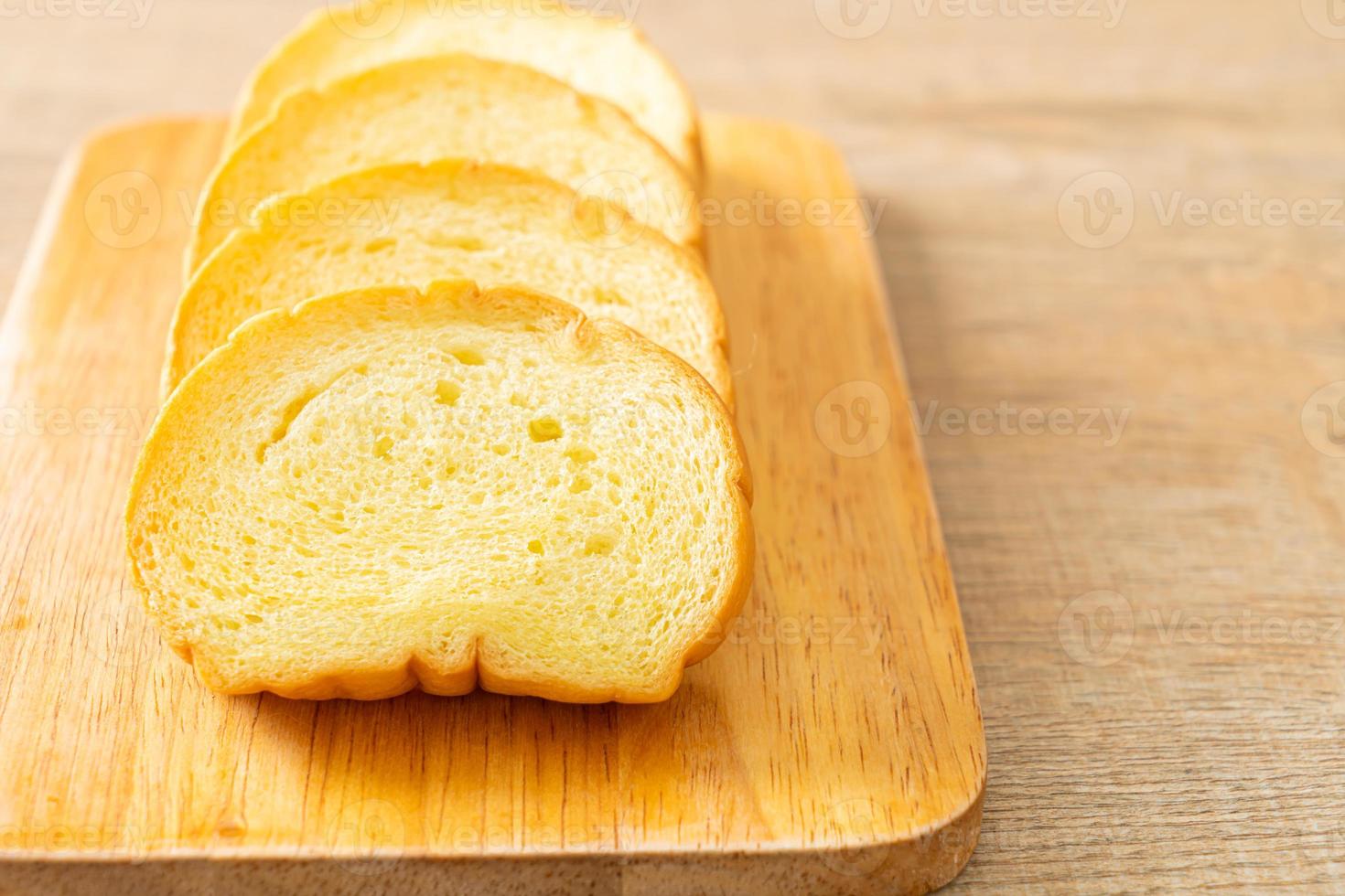 potatoes bread sliced on wood board photo