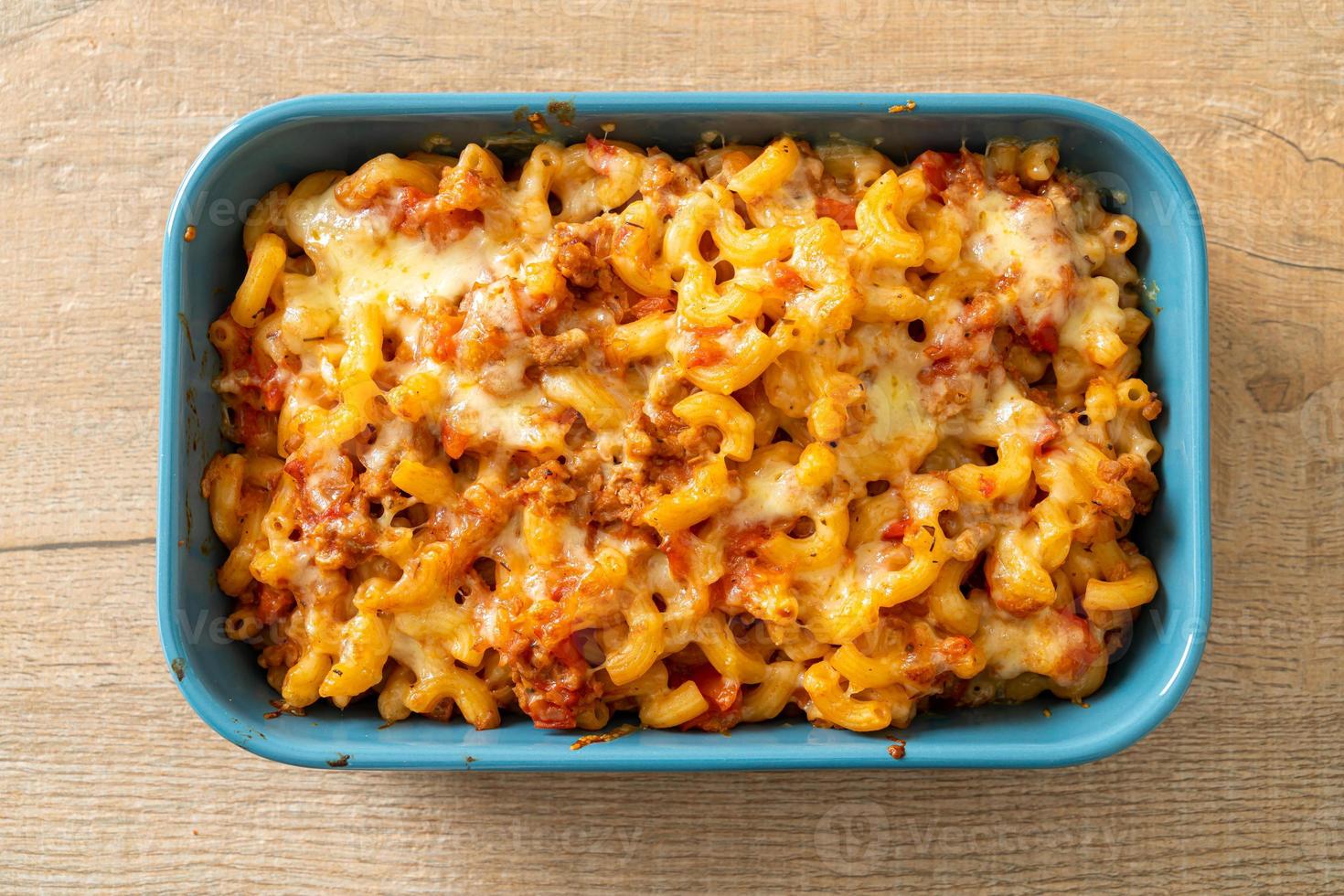 homemade macaroni bolognese with cheese photo