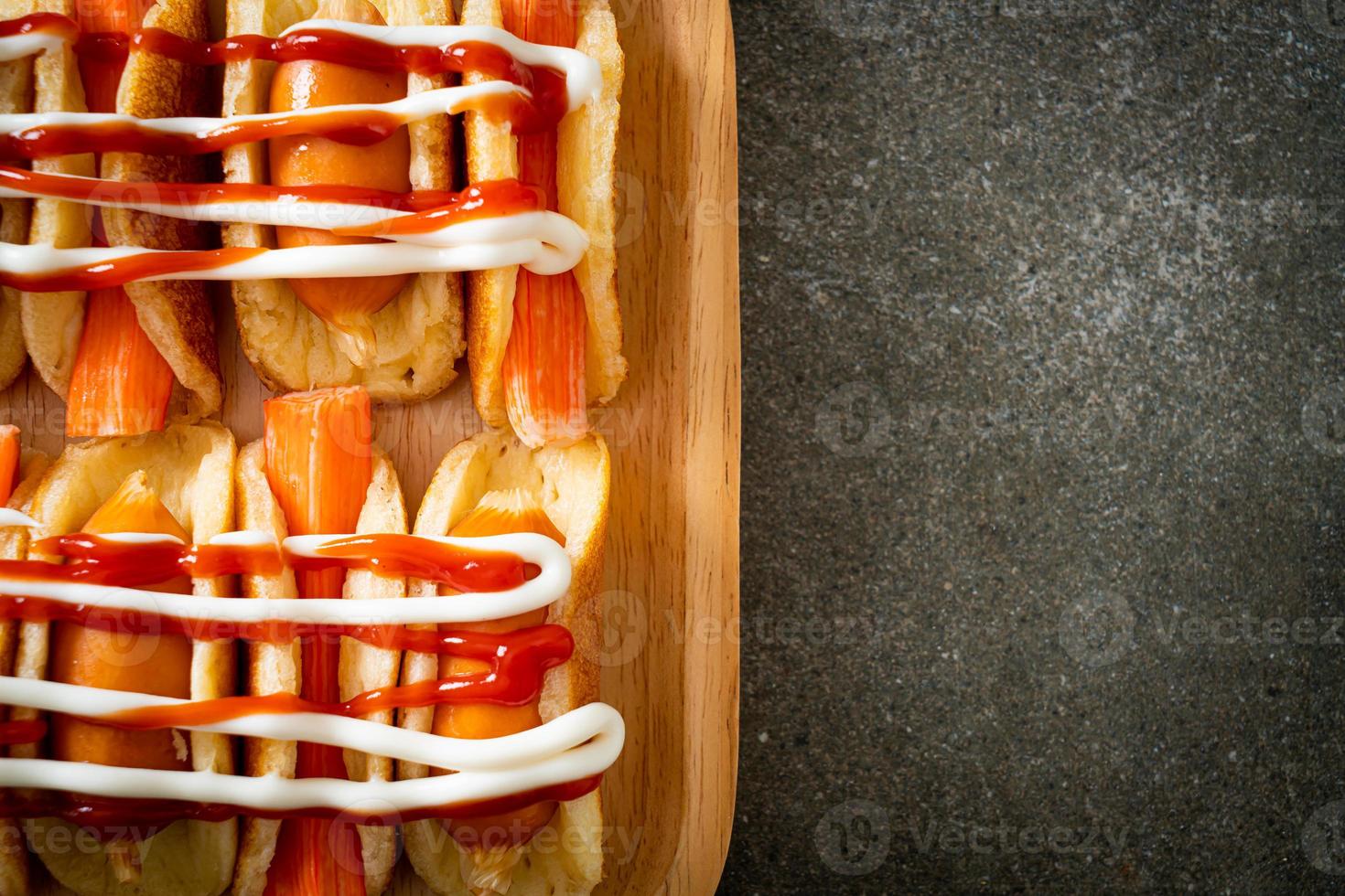 flat pancake roll with sausage and crab stick photo