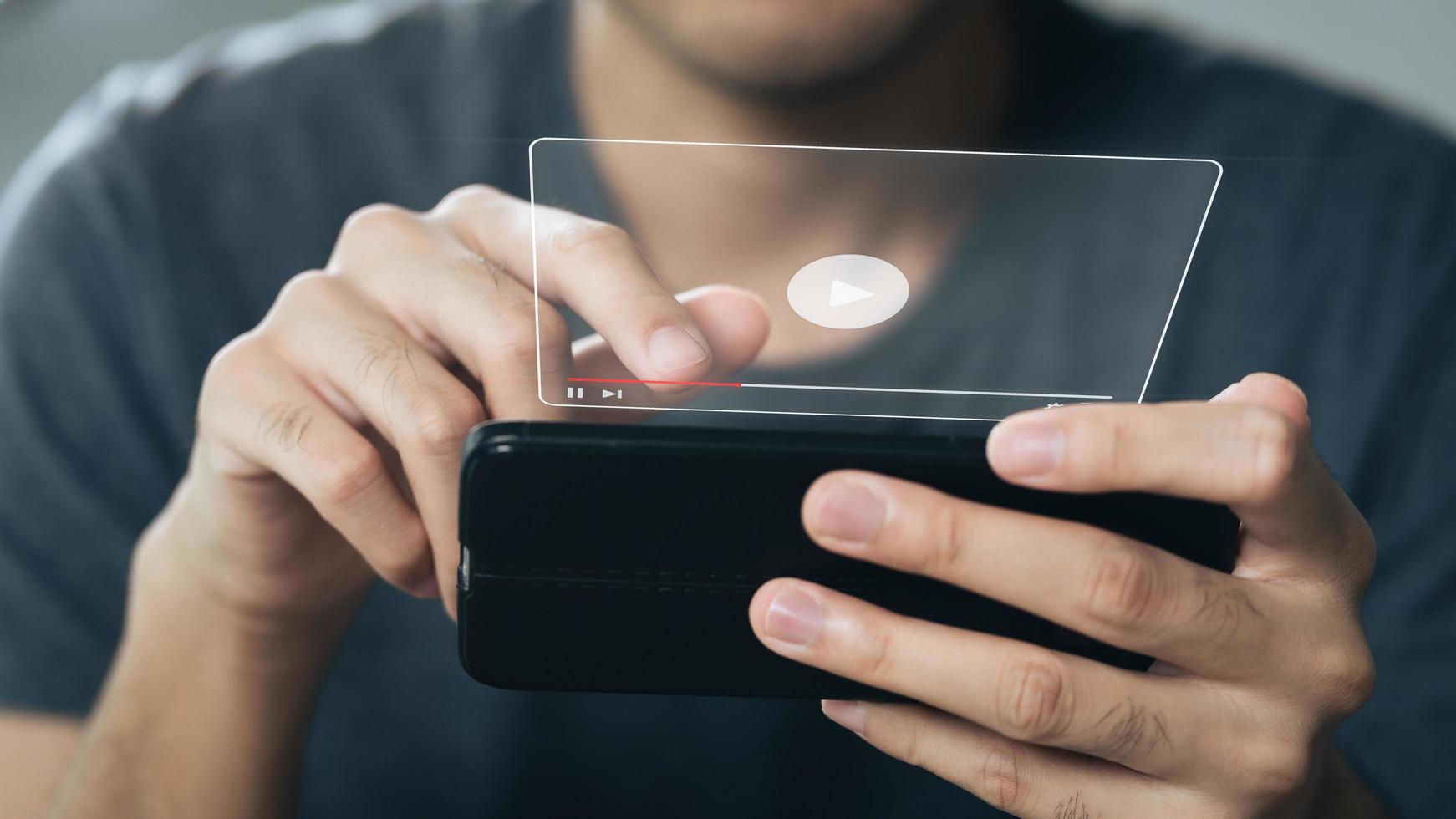 Man using smartphone for watching video on internet, online streaming, online class, content creator photo
