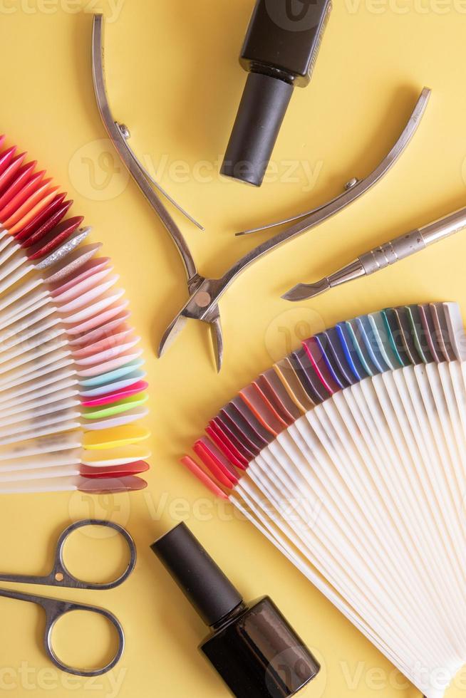 Tools for manicure flat lay on a colored background. Covering nails with gel polish concept photo