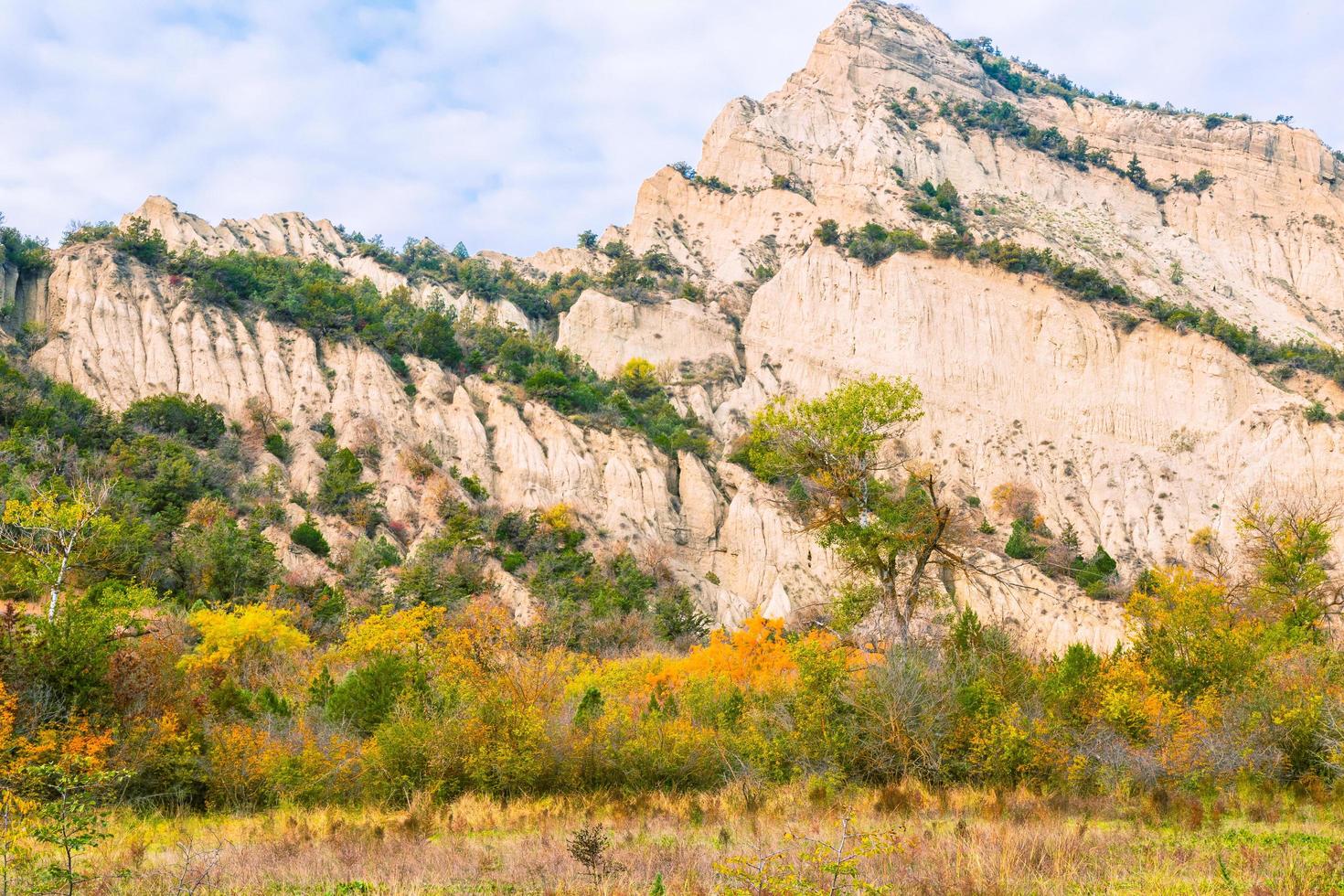 Stunning sharp edge cliff in vashlovani national park area with beautiful colorful autumn trees photo