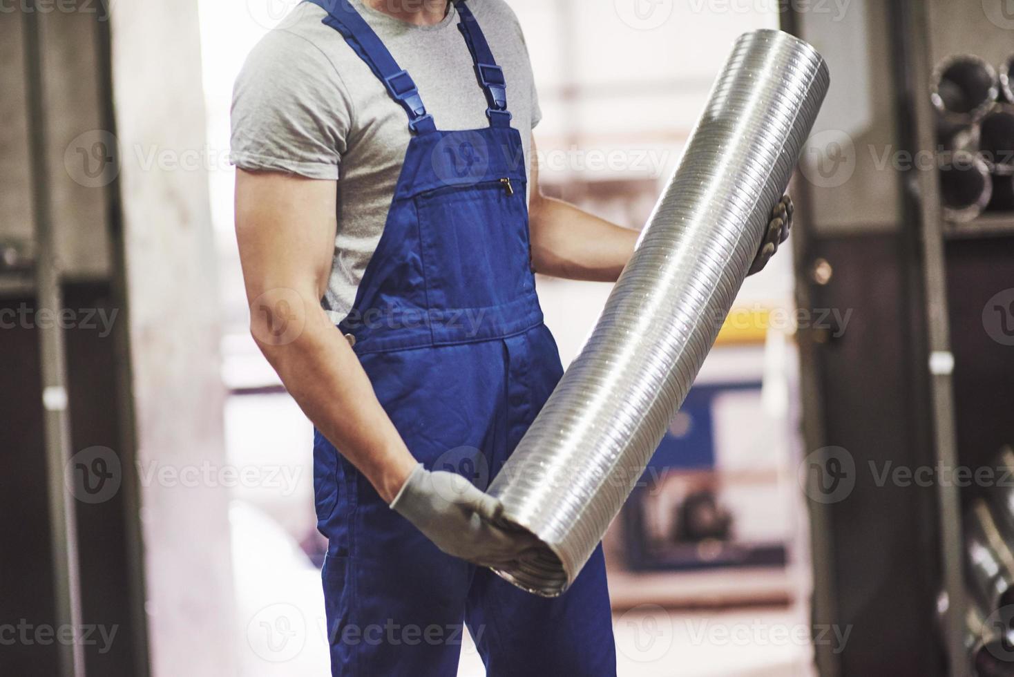A portrait of handsome metal industry worker in factory. photo