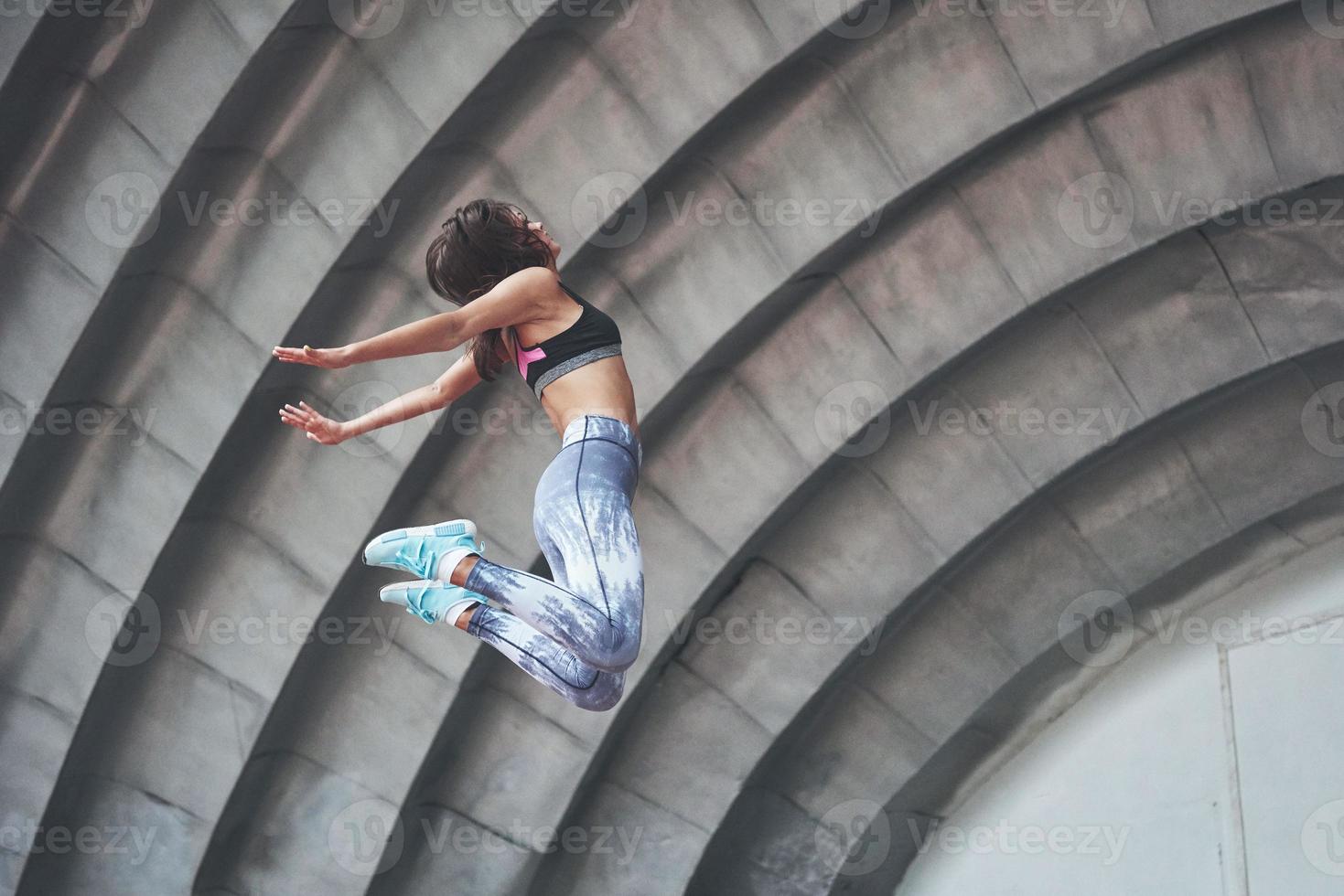 Photo of a beautiful woman doing parkour