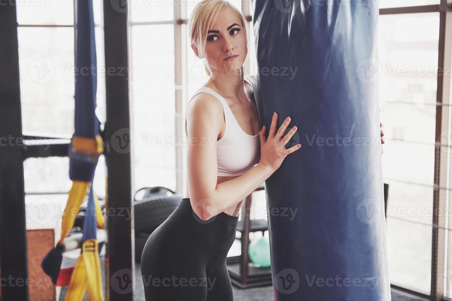 Woman lifting weights in gym Concept workout healthy lifestyle sport photo