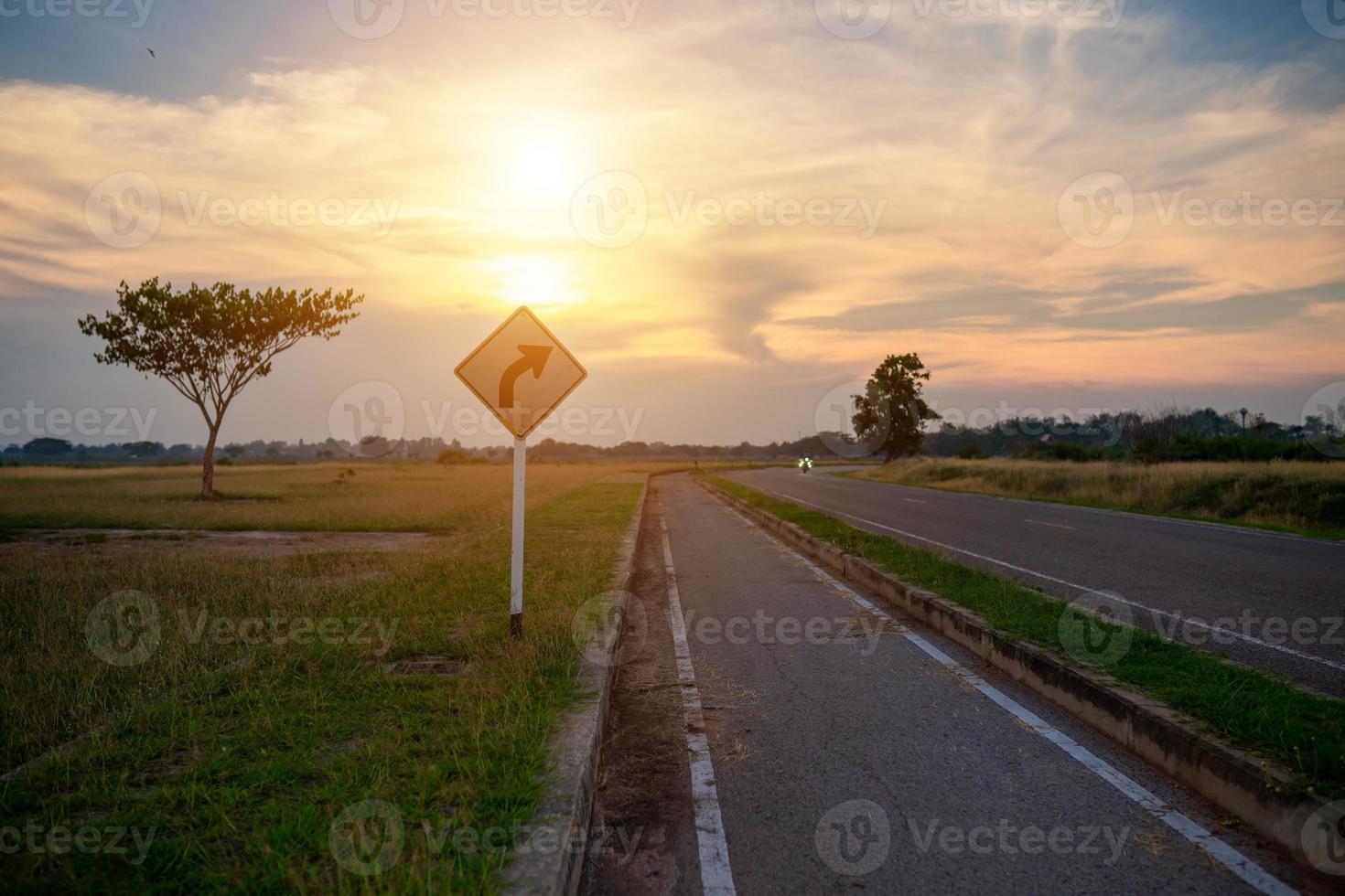 Traffic signs and bike paths during the sunset photo