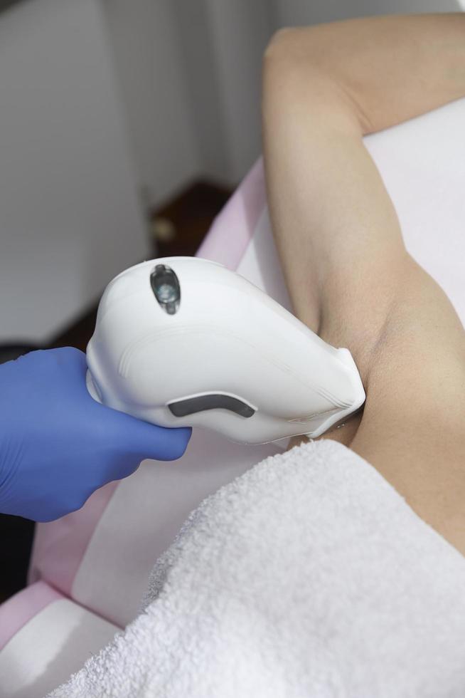 Beautician Giving Epilation Laser Treatment To Woman photo