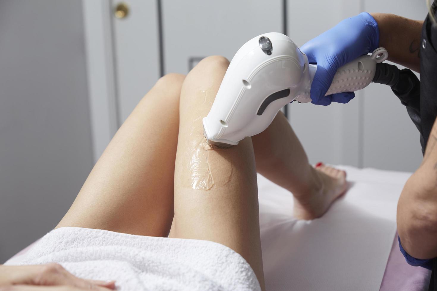 Beautician Giving Epilation Laser Treatment To Woman photo