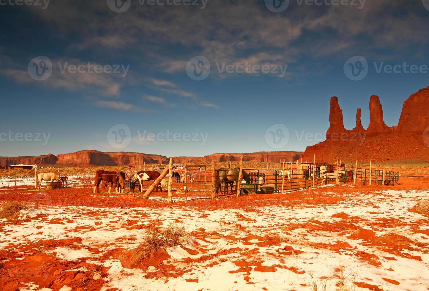 The Three Sisters Formation in Monument Valley Next to a Horse Stable photo