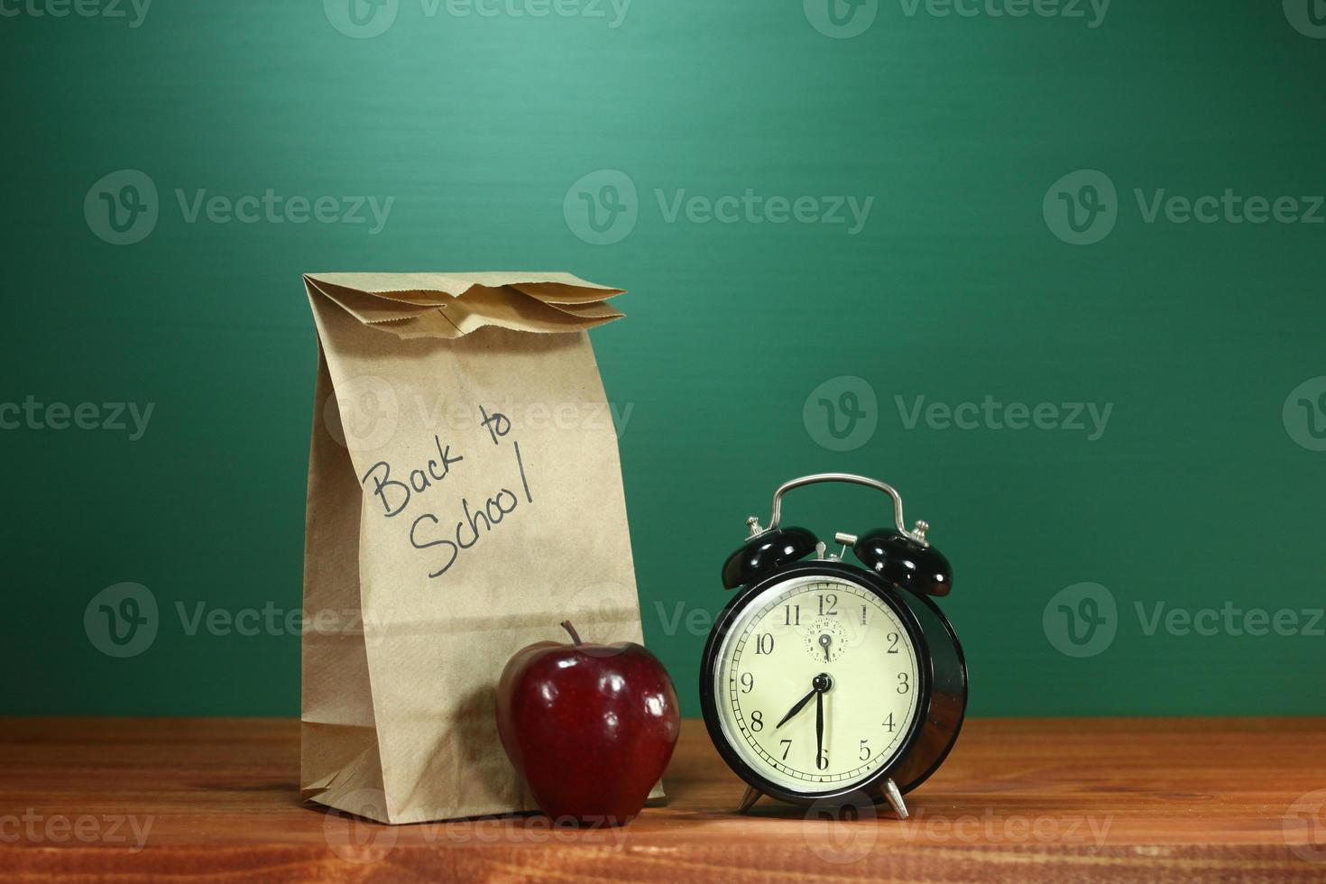 School Lunch, Apple and Clock on Desk at School photo