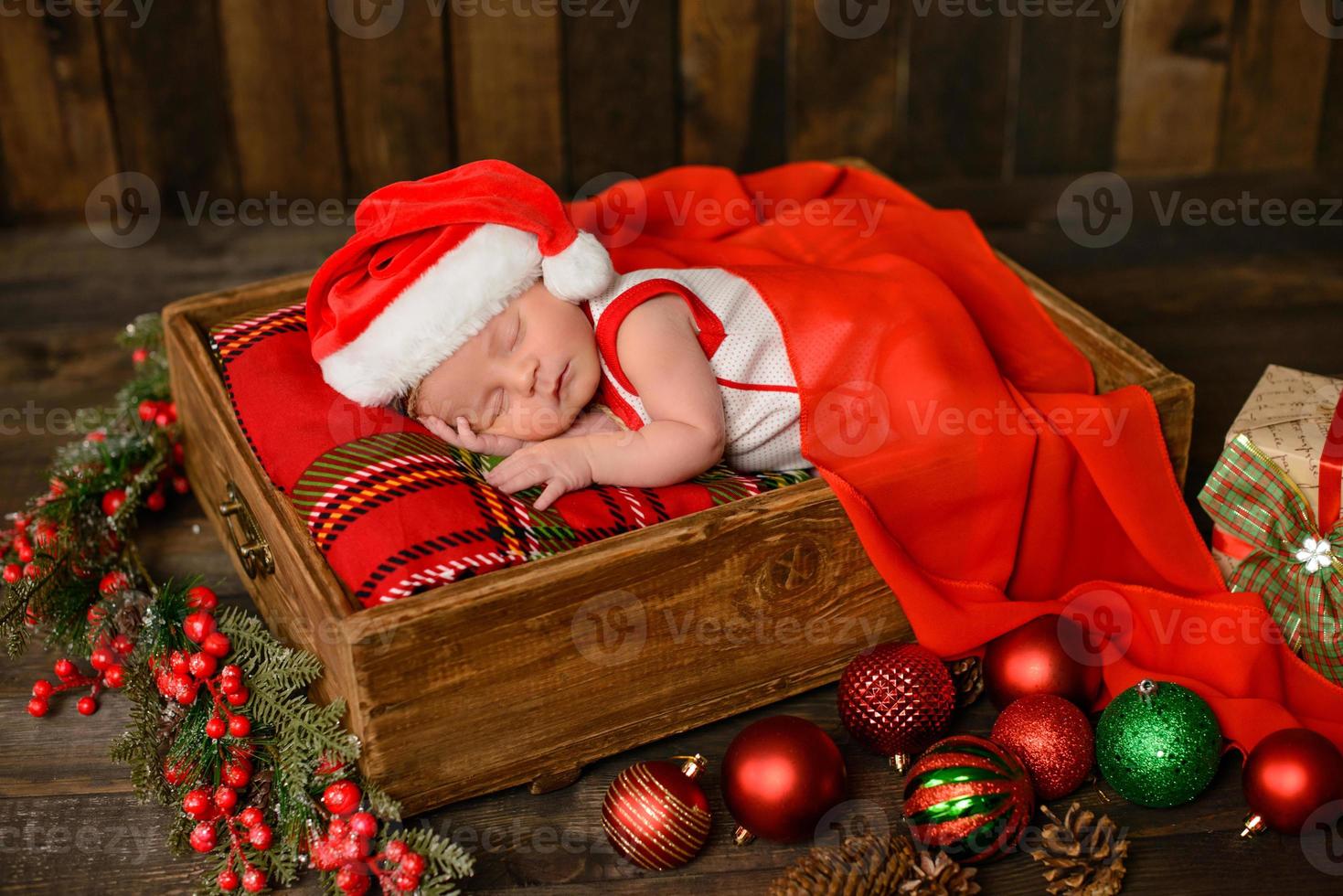 Little newborn girl eight days old in Christmas suit photo