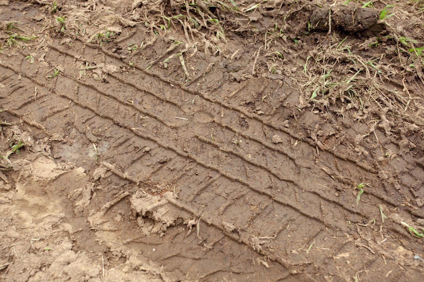 car wheel tracks on the ground photo