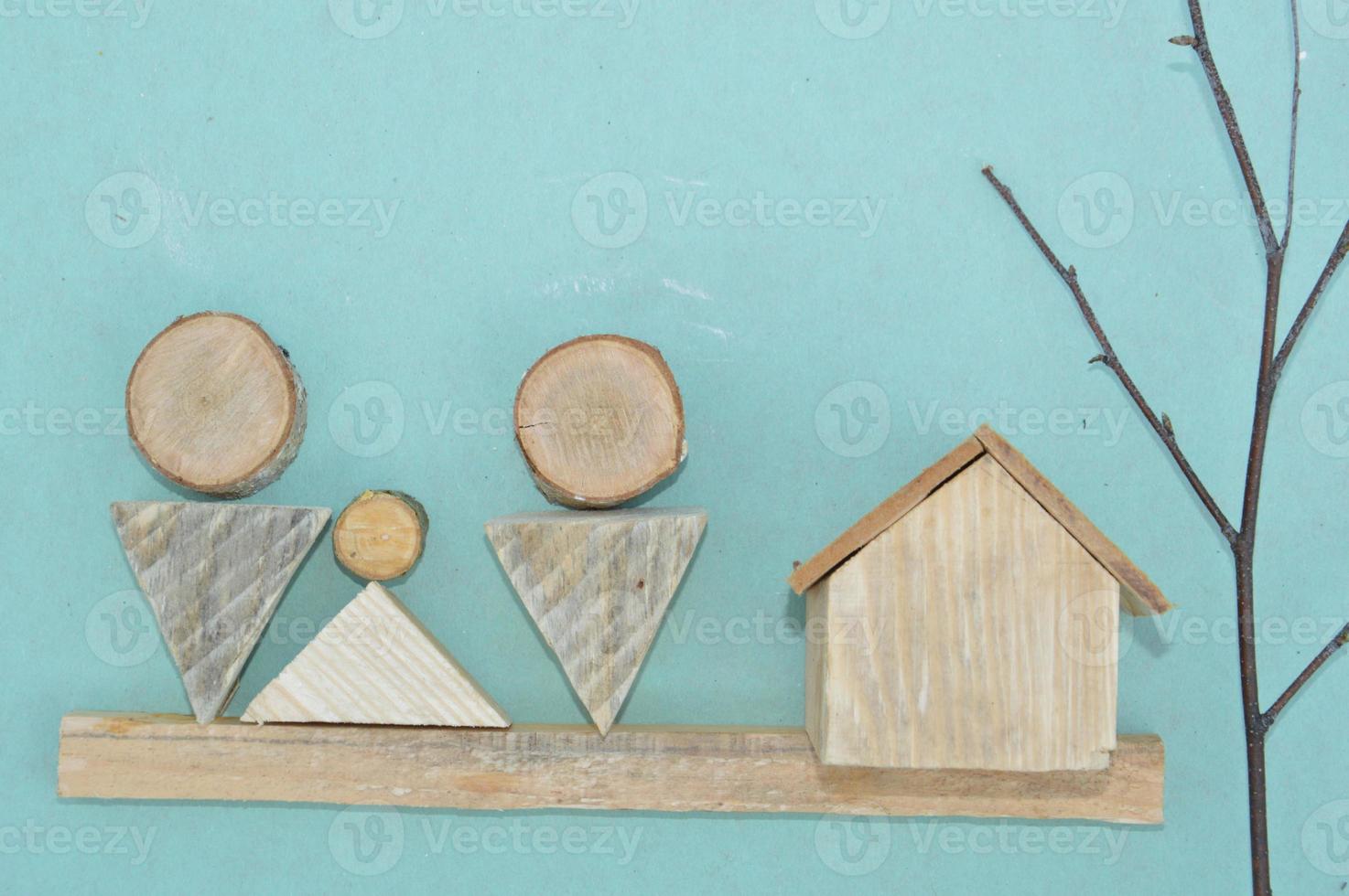 Wooden model of a house and family photo