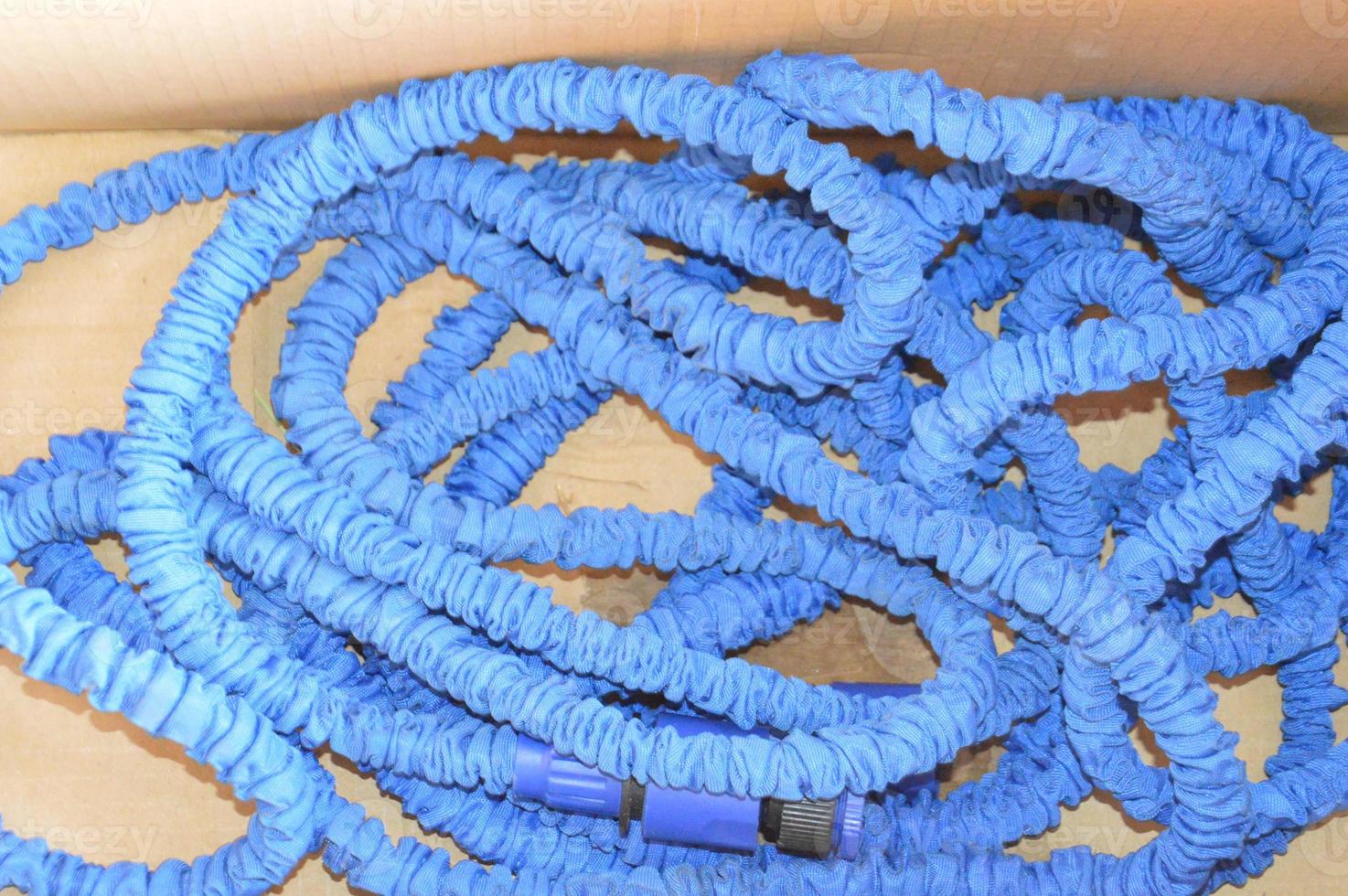 Blue stretch hose for garden watering in a box photo