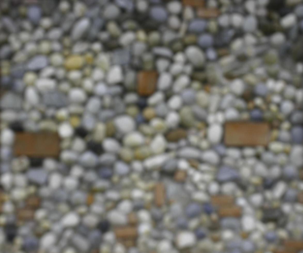 blurred blackground  background made of a wall with pebbles photo
