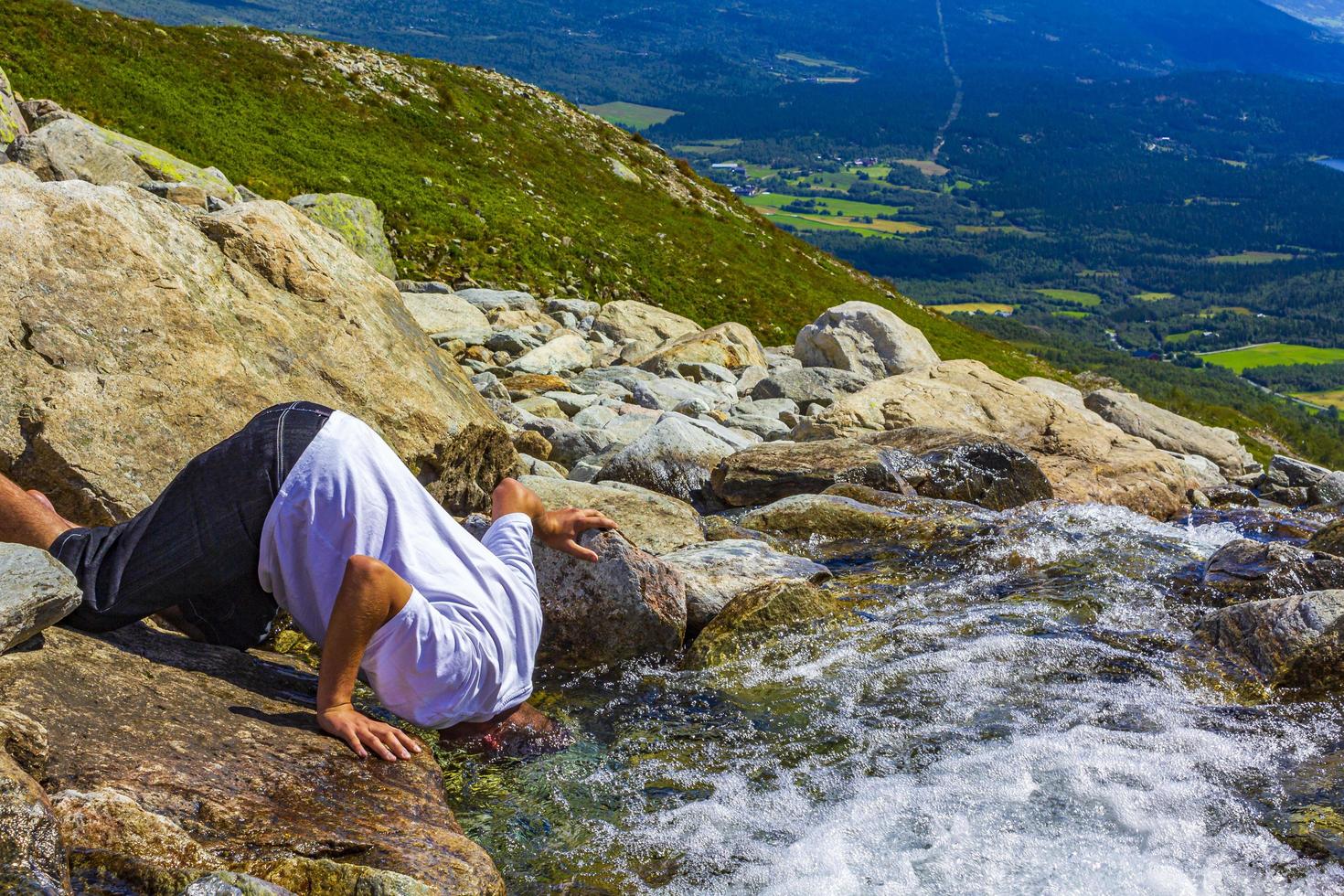 Hold your head under water waterfall in a cold river photo