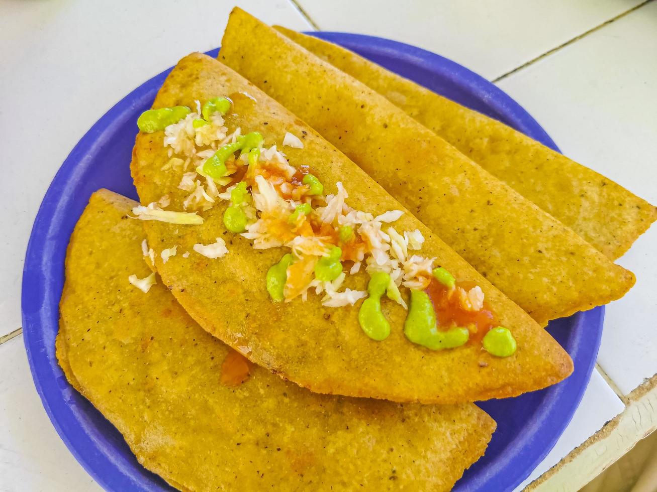 Mexican empanada on blue plate from Playa del Carmen Mexico photo